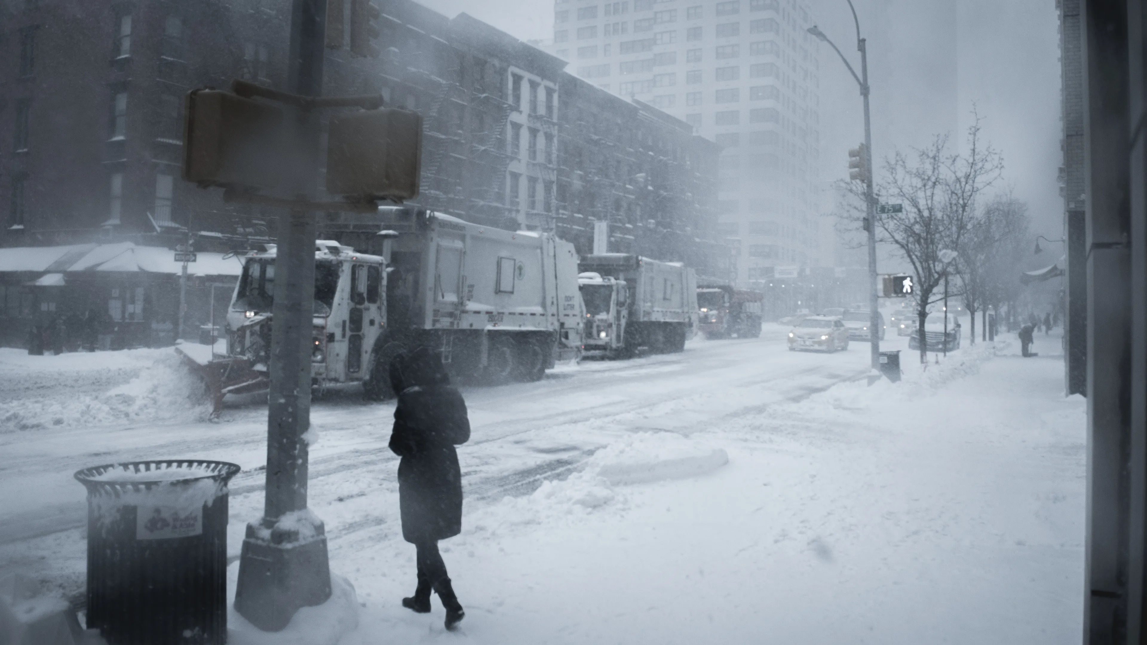 "Snow Days In NYC" is a collection of images that were taken over the course of 6 years. Each image documents an everyday New Yorker bravely making their way through the storm as the winds whip snow into their faces. Each step taken is calculated. One misstep could lead to having a speedy and painful introduction to the pavement.