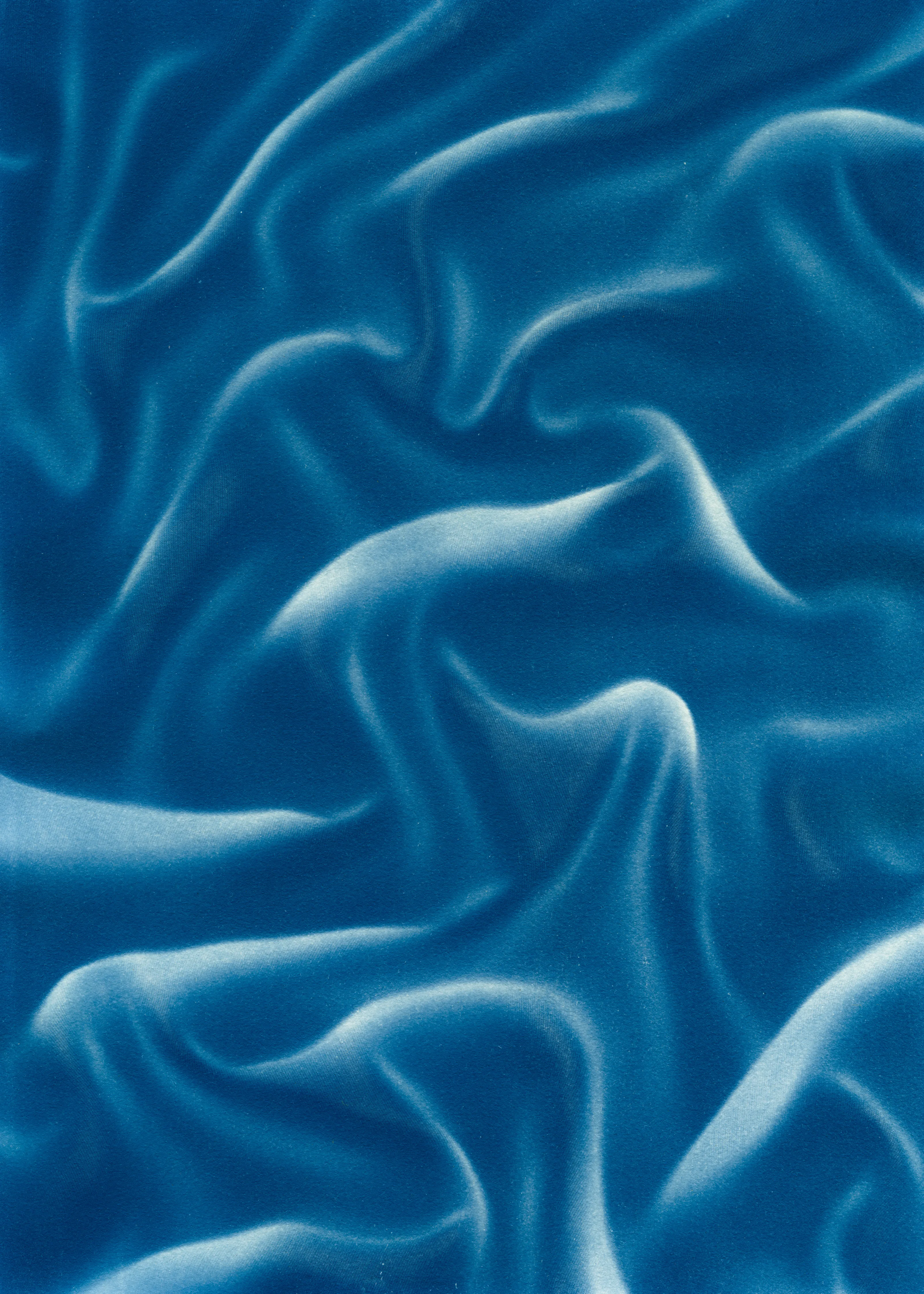 Beyond the Veil is simultaneously a melding of mediums as a means to sculpt with light, and an attempt to
capture the fabric of reality. I work with cyanotype, an alternative photography process that yields blue-
toned impressions when exposed to UV light. 
Cyanotype allows me to interact directly with light, one of the most subtle phenomena we experience day to day. Combined with sculpture, collage and drawing, the
cyanotype process is a powerful creative tool fueled by the sun. Working with light and shadow is to
become aware of how they describe our reality.

Created over the past eight months, this collection has been my safe haven from the world. A finger on the
pulse of something deeper than the chaotic rhythm of daily life, an album of captive sunlight and
experiences preserved in blue. The stillness of winter sunlight, silent rolling waves, a slow, even breath. I
hope you too can find solace here.