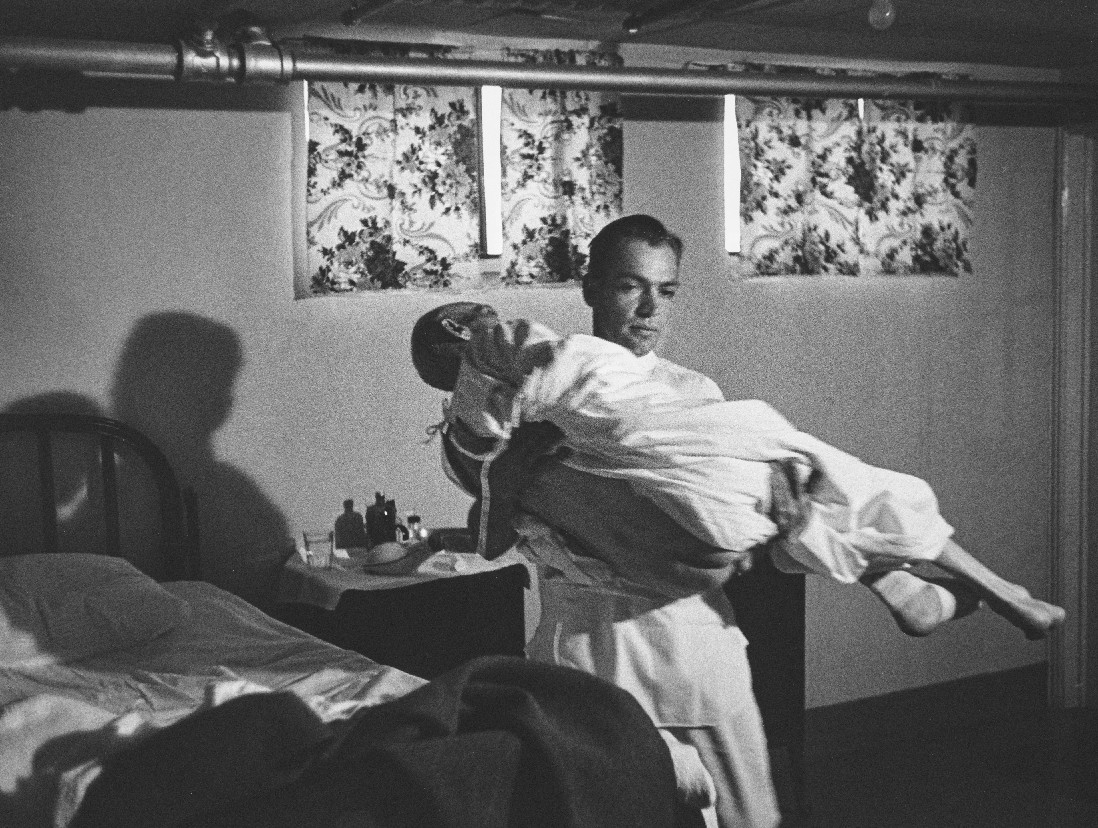 After World War II, LIFE magazine assigned staff photographer W. Eugene Smith a human interest story about a doctor in rural America. They sent him to Kremmling, a small and remote town in northern Colorado. His subject: Dr. Ernest Ceriani. 

At first, Smith observed Dr. Ceriani and earned the trust of the townspeople. He wrote: 'I spent four weeks living with him. I made very few pictures at first. ... I simply faded into the wallpaper and waited.' The resulting story spanned 11 pages in LIFE's September 20, 1948 edition.

Smith's intimate series depicts Dr. Ceriani as a heroic yet weary figure who made house calls, delivered babies, and tended to the young and old alike. Through Smith's lens, Ceriani carries the weight of the world on his shoulders as the only doctor within 400 miles. 

A LIFE compendium later summarized 'Country Doctor' as "an instant classic when published, establishing Smith as a master of the commanding young art form of the photo essay, and solidifying his stature as one of the most passionate and influential photojournalists of the 20th century." As TIME magazine explained in its 2016 compendium '100 Photographs: The Most Influential Images of All Time': "By digging so deeply into his assignment, Smith created a singular, starkly intimate glimpse into the life of a remarkable man. It became not only the most influential photo essay in history but the aspirational template for the form.'"