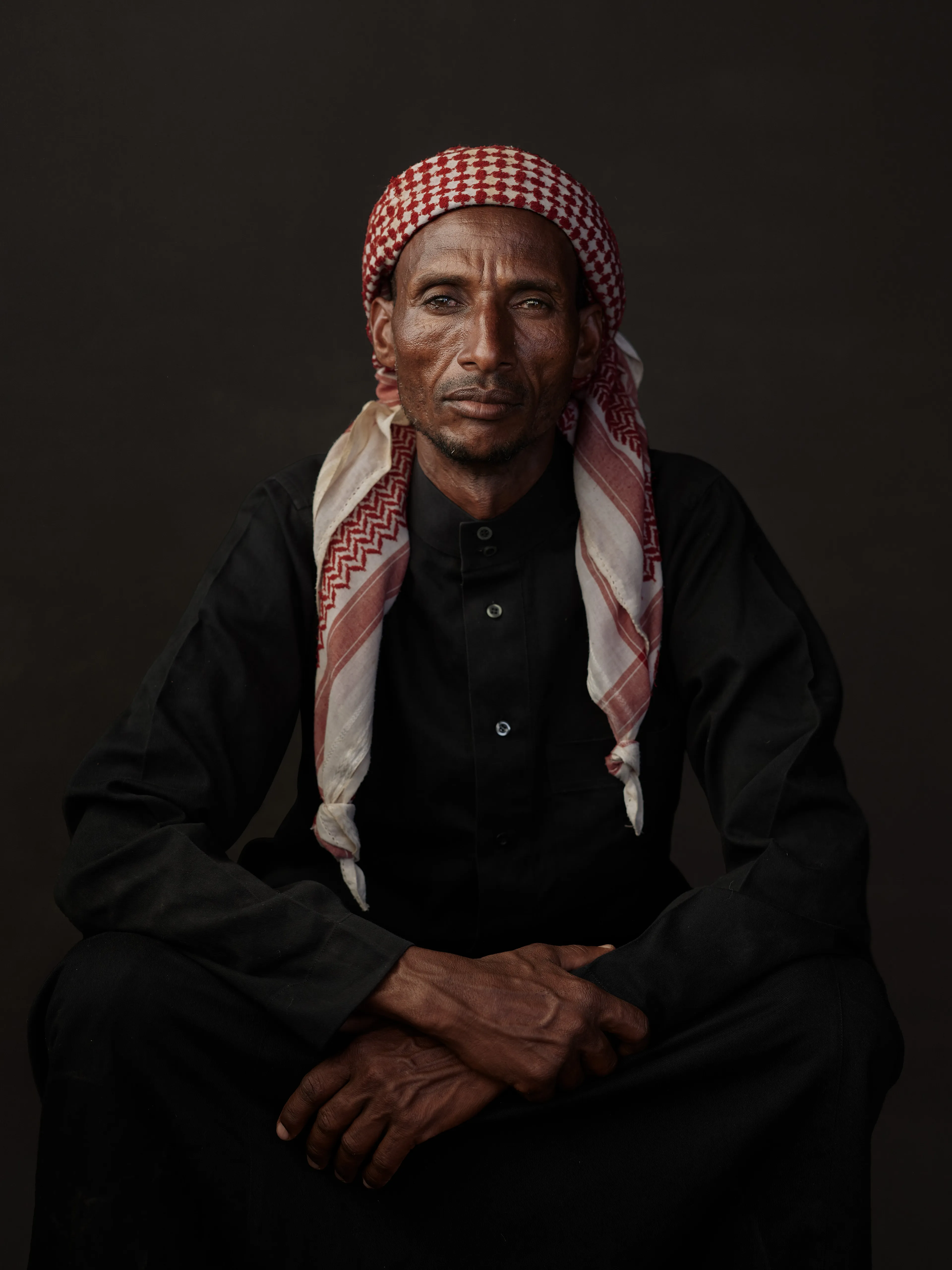 Joey L. returns to Quantum with Ethiopia - Portraits: a collection directly linked to his genesis drop during Season 1. For every environmental image from Joey’s first drop, there is a portrait companion.

“For years, we dragged our nomadic studio tent across almost every region of Ethiopia. In our tent, everyone was equal. We captured pure magic. Every kind of person entered and had their portrait taken. The tent was our little fantasy world. It was the Ethiopia that we dreamed of, even when the reality outside of it was sometimes stricken with searing pain. Each portrait was a tribute to a distinct region of the country. Disconnected cultural threads were woven together in a cohesive visual style in order to truly see Ethiopia— which itself is a modern nation state, but is also the sum of all the diverse people who inhabit it.”

Joey’s portraits alternating on red and black backdrops are the visual backbone of my forthcoming book “Ethiopia” (Insight Editions, January 2023), which compiles 13 years of work.

The tent itself is a metal frame modified with diffusion material made out of netela fabric, which is a hand-spun cotton perfected by Dorze craftspeople. Every portrait is created with natural light molded from the tent itself and photographed on location.

Somali, Hadawe, 
Somali Region, Ethiopia
December 2020
