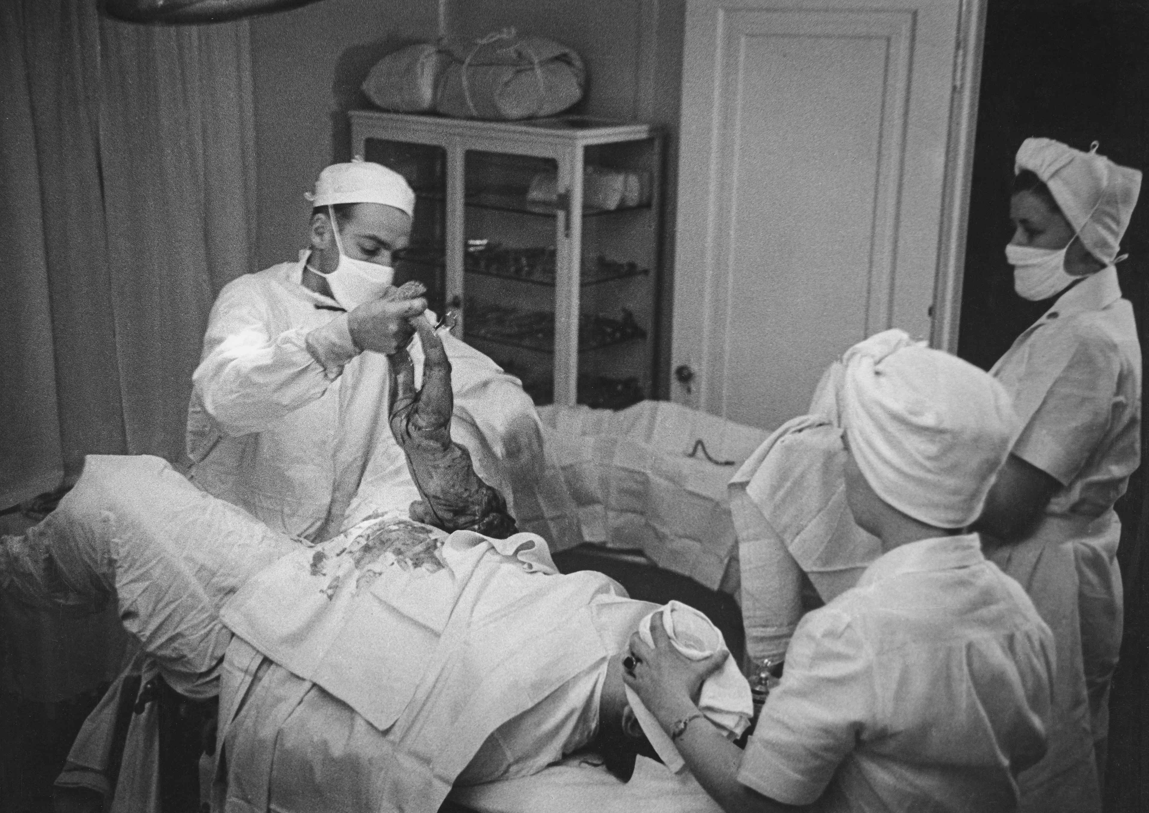 After World War II, LIFE magazine assigned staff photographer W. Eugene Smith a human interest story about a doctor in rural America. They sent him to Kremmling, a small and remote town in northern Colorado. His subject: Dr. Ernest Ceriani. 

At first, Smith observed Dr. Ceriani and earned the trust of the townspeople. He wrote: 'I spent four weeks living with him. I made very few pictures at first. ... I simply faded into the wallpaper and waited.' The resulting story spanned 11 pages in LIFE's September 20, 1948 edition.

Smith's intimate series depicts Dr. Ceriani as a heroic yet weary figure who made house calls, delivered babies, and tended to the young and old alike. Through Smith's lens, Ceriani carries the weight of the world on his shoulders as the only doctor within 400 miles. 

A LIFE compendium later summarized 'Country Doctor' as "an instant classic when published, establishing Smith as a master of the commanding young art form of the photo essay, and solidifying his stature as one of the most passionate and influential photojournalists of the 20th century." As TIME magazine explained in its 2016 compendium '100 Photographs: The Most Influential Images of All Time': "By digging so deeply into his assignment, Smith created a singular, starkly intimate glimpse into the life of a remarkable man. It became not only the most influential photo essay in history but the aspirational template for the form.'"