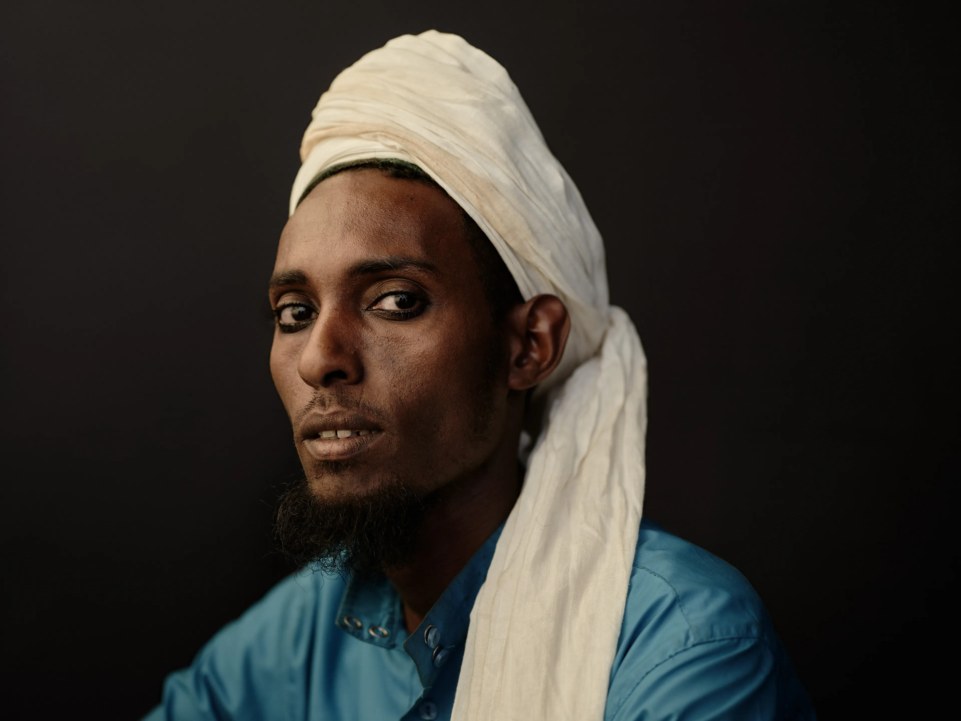 Joey L. returns to Quantum with Ethiopia - Portraits: a collection directly linked to his genesis drop during Season 1. For every environmental image from Joey’s first drop, there is a portrait companion.

“For years, we dragged our nomadic studio tent across almost every region of Ethiopia. In our tent, everyone was equal. We captured pure magic. Every kind of person entered and had their portrait taken. The tent was our little fantasy world. It was the Ethiopia that we dreamed of, even when the reality outside of it was sometimes stricken with searing pain. Each portrait was a tribute to a distinct region of the country. Disconnected cultural threads were woven together in a cohesive visual style in order to truly see Ethiopia— which itself is a modern nation state, but is also the sum of all the diverse people who inhabit it.”

Joey’s portraits alternating on red and black backdrops are the visual backbone of my forthcoming book “Ethiopia” (Insight Editions, January 2023), which compiles 13 years of work.

The tent itself is a metal frame modified with diffusion material made out of netela fabric, which is a hand-spun cotton perfected by Dorze craftspeople. Every portrait is created with natural light molded from the tent itself and photographed on location.

Harar Jugol, 
Harari Region,  Ethiopia  
December 2020