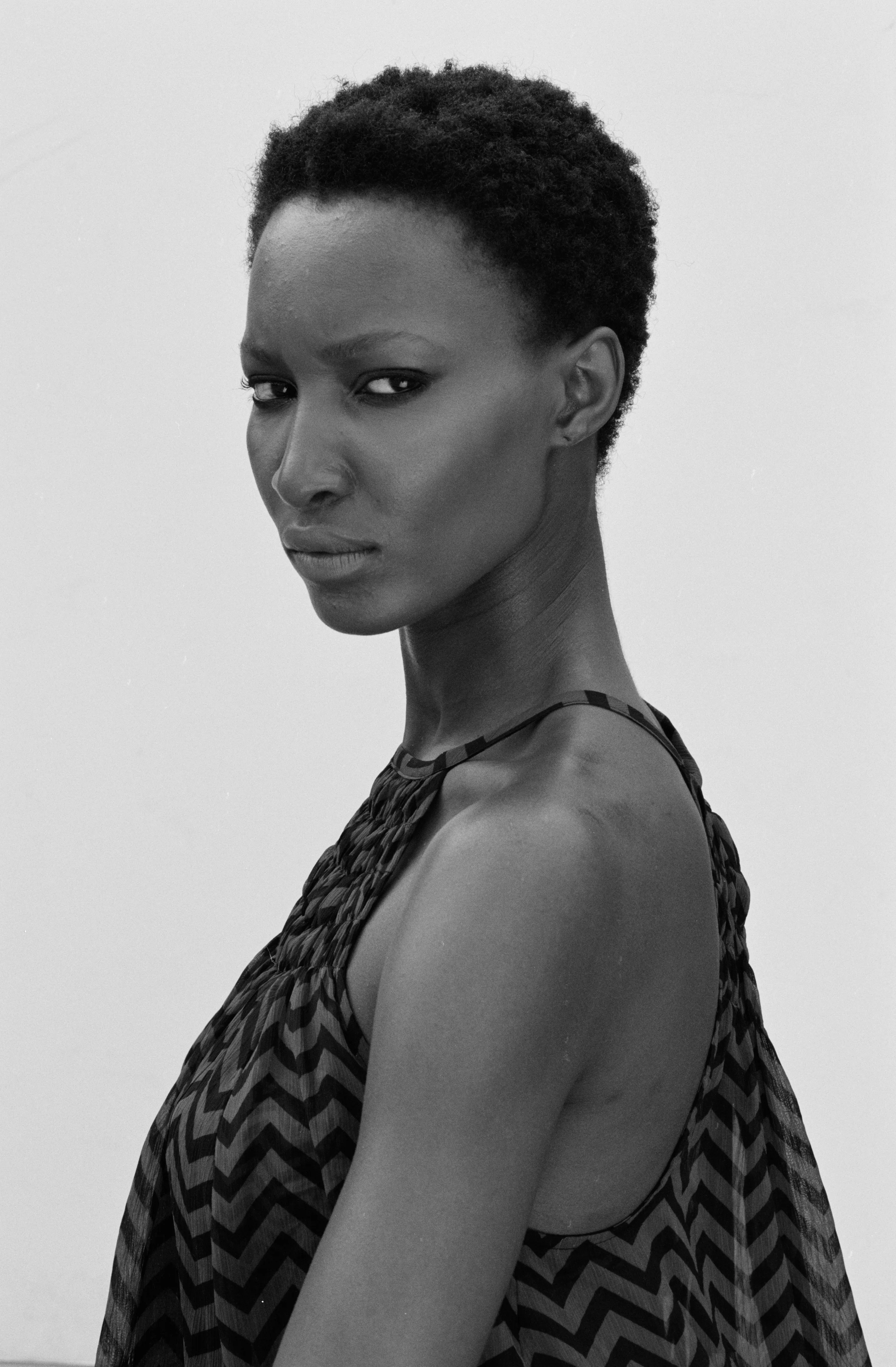 For centuries, the art world was seen through the eyes of a small few who, under a patriarchal society, chose the aesthetic and the narrative—and whose main depiction of the sacred female body was as an objectified and sexualized woman. 

Delphine Diallo aims to change this dynamic. Her intention is for every woman she photographs to feel the image she makes of them is a personal gift. “I am not taking pictures, I am giving pictures,” as Diallo puts it. By engaging in intimate conversations with her subjects, Delphine removes the sense of vulnerability that often comes with being photographed. Working with body painters and jewelry and mask makers, Diallo also uses traditional mythology and spiritual symbols to empower her subjects. Her portraiture is all about connection and exchange. She believes women are deep beings and connects with them on an emotional level. The French-Senegalese photographer spends more time speaking with her subjects than photographing them. 

Diallo’s photographs are never discriminating, yet deeply communicative, and portray women beyond judgment, soaking up their limitless beauty. Diallo's works are meant to encourage every woman to write a personal narrative, to take a stand, to have a firm voice. No preparatory models, sketches, or plans lay behind her photographs, which depict only outstanding feminine painted bodies. It is all a part of the vision flowing out of the artist's mind, grounded in her right brain hemisphere, predominant in her energetic and vibrant personality. 

Drawing elements from eastern mythology and philosophy, whilst always ennobling and empowering women, her practice is reminiscent of Oriental 19th-century painting. Looking at Krishnamurti, Frantz Fanon, Joseph Campbell, Bruce Lee, Aimé Césaire, and A.D. Wilson as deep inspirational sources, her photographs raise awareness, appealing to all women to awaken their senses. Diallo immerses herself in the realm of the feminine universe and her eloquent portraiture technique unveils and stirs unexplored emotion and insight meant to reach beyond appearances. 

“We are in constant search for wonder and growth. I see art as a vessel to express consciousness and as an access to diffuse wisdom, enlightenment, fear, beauty, ugliness, mystery, faith, strength, fearlessness, and universal matter”.

Artist: Delphine Diallo
Date: 2011