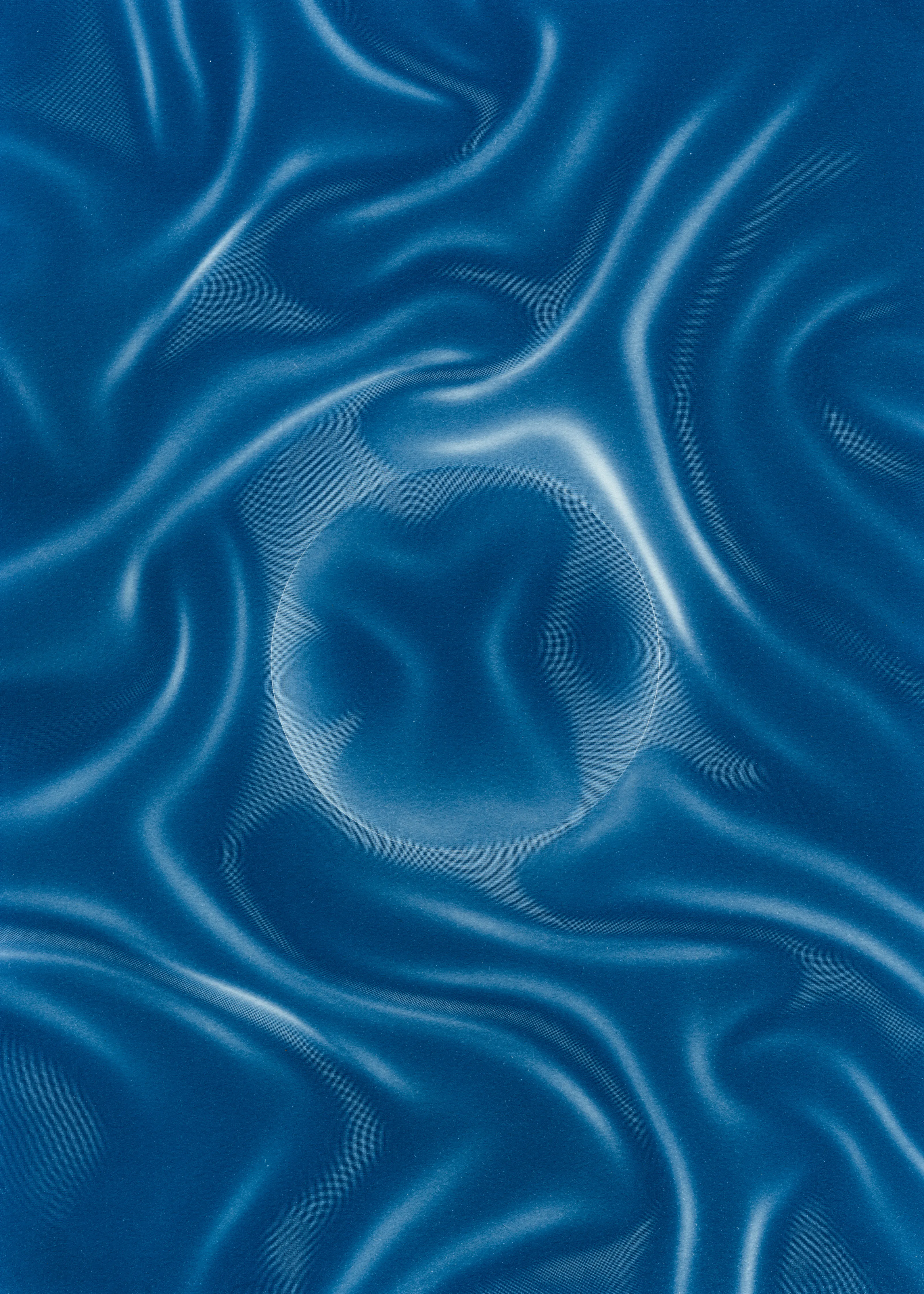 Beyond the Veil is simultaneously a melding of mediums as a means to sculpt with light, and an attempt to
capture the fabric of reality. I work with cyanotype, an alternative photography process that yields blue-
toned impressions when exposed to UV light. 
Cyanotype allows me to interact directly with light, one of the most subtle phenomena we experience day to day. Combined with sculpture, collage and drawing, the
cyanotype process is a powerful creative tool fueled by the sun. Working with light and shadow is to
become aware of how they describe our reality.

Created over the past eight months, this collection has been my safe haven from the world. A finger on the
pulse of something deeper than the chaotic rhythm of daily life, an album of captive sunlight and
experiences preserved in blue. The stillness of winter sunlight, silent rolling waves, a slow, even breath. I
hope you too can find solace here.