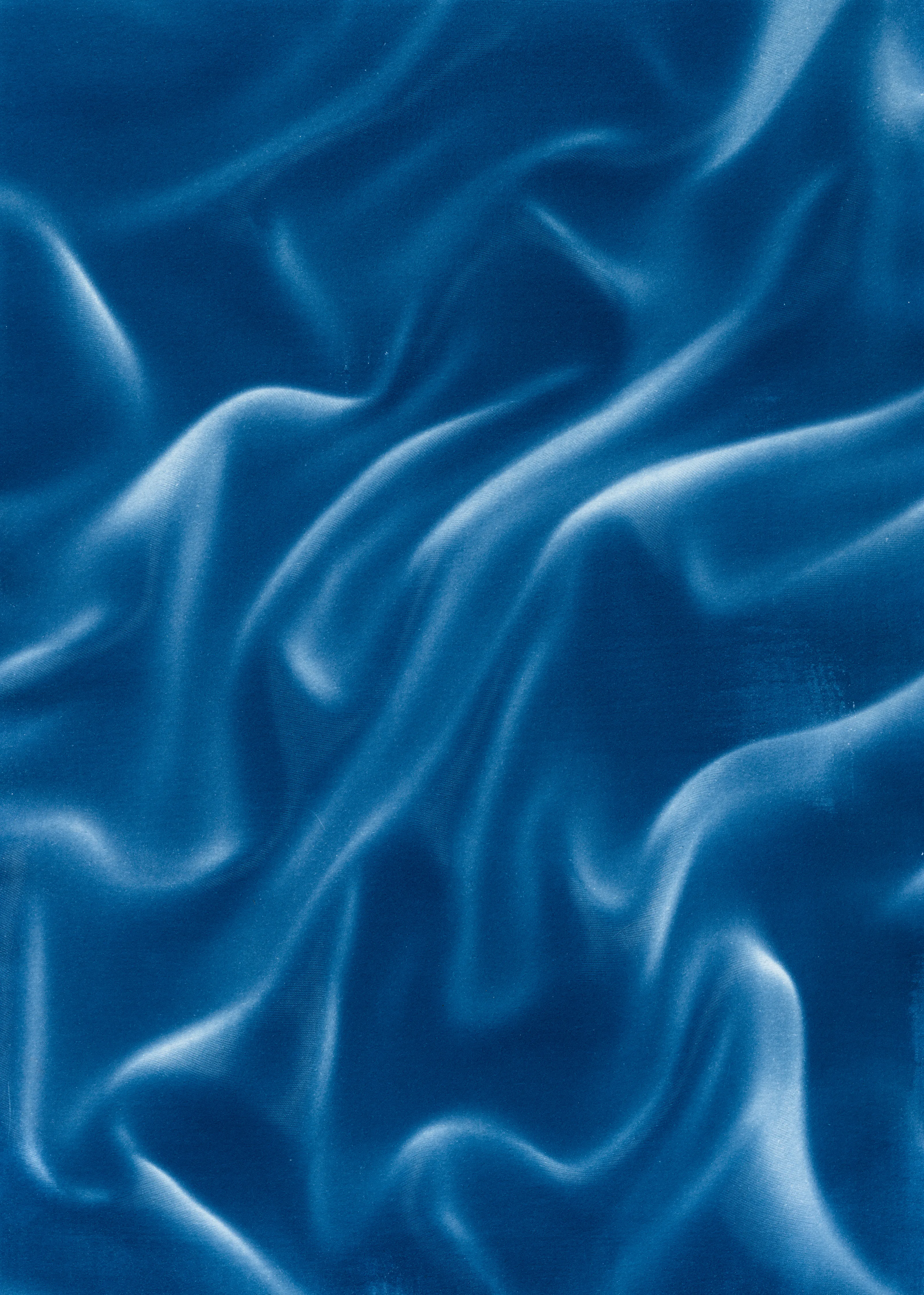 Beyond the Veil is simultaneously a melding of mediums as a means to sculpt with light, and an attempt to
capture the fabric of reality. I work with cyanotype, an alternative photography process that yields blue-
toned impressions when exposed to UV light. 
Cyanotype allows me to interact directly with light, one of the most subtle phenomena we experience day to day. Combined with sculpture, collage and drawing, the
cyanotype process is a powerful creative tool fueled by the sun. Working with light and shadow is to
become aware of how they describe our reality.

Created over the past eight months, this collection has been my safe haven from the world. A finger on the
pulse of something deeper than the chaotic rhythm of daily life, an album of captive sunlight and
experiences preserved in blue. The stillness of winter sunlight, silent rolling waves, a slow, even breath. I
hope you too can find solace here.