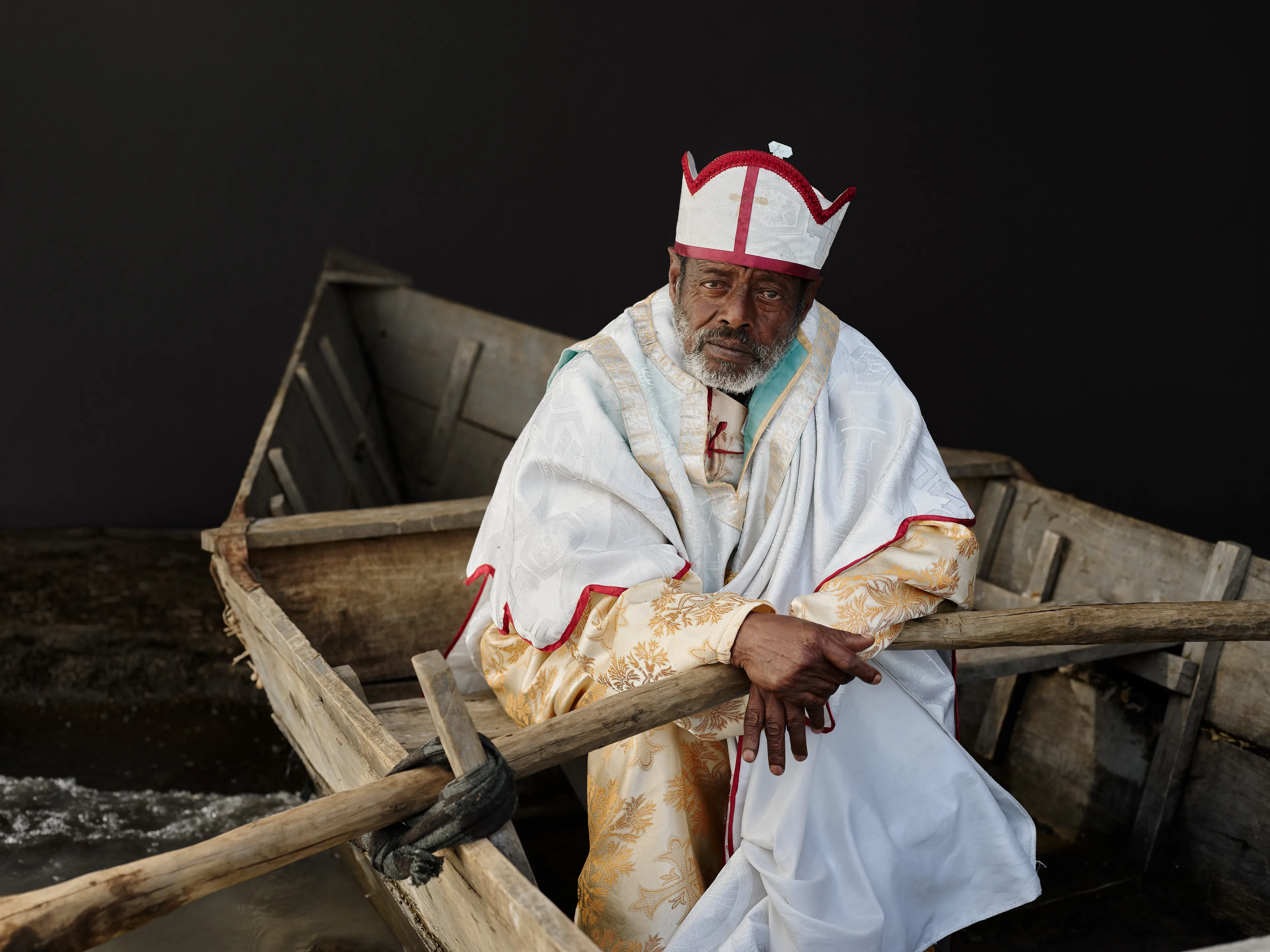 Joey L. returns to Quantum with Ethiopia - Portraits: a collection directly linked to his genesis drop during Season 1. For every environmental image from Joey’s first drop, there is a portrait companion.

“For years, we dragged our nomadic studio tent across almost every region of Ethiopia. In our tent, everyone was equal. We captured pure magic. Every kind of person entered and had their portrait taken. The tent was our little fantasy world. It was the Ethiopia that we dreamed of, even when the reality outside of it was sometimes stricken with searing pain. Each portrait was a tribute to a distinct region of the country. Disconnected cultural threads were woven together in a cohesive visual style in order to truly see Ethiopia— which itself is a modern nation state, but is also the sum of all the diverse people who inhabit it.”

Joey’s portraits alternating on red and black backdrops are the visual backbone of my forthcoming book “Ethiopia” (Insight Editions, January 2023), which compiles 13 years of work.

The tent itself is a metal frame modified with diffusion material made out of netela fabric, which is a hand-spun cotton perfected by Dorze craftspeople. Every portrait is created with natural light molded from the tent itself and photographed on location.

 Lake Ziway, 
Oromia Region, Ethiopia  
June 2020