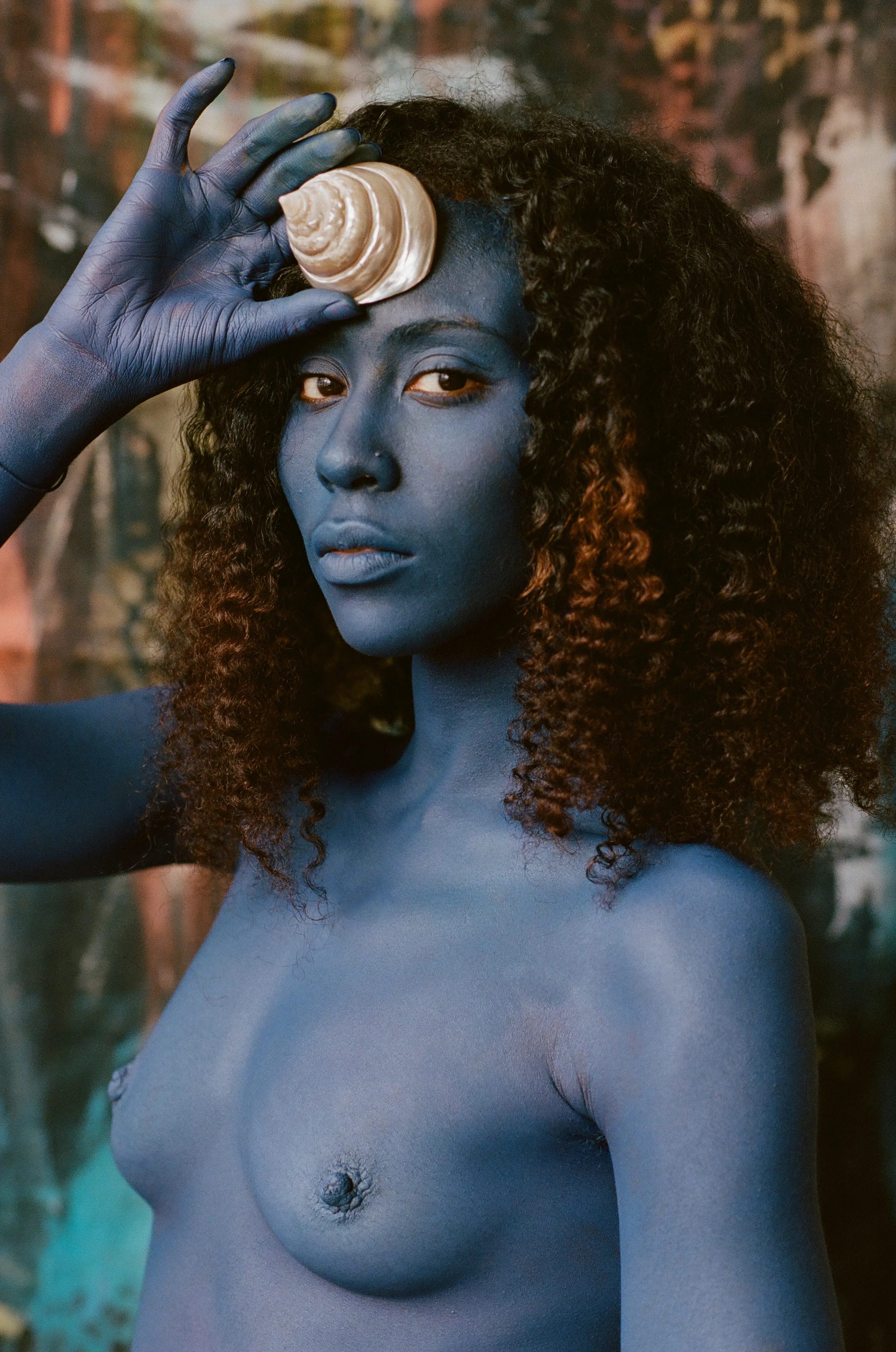 For centuries, the art world was seen through the eyes of a small few who, under a patriarchal society, chose the aesthetic and the narrative—and whose main depiction of the sacred female body was as an objectified and sexualized woman. 

Delphine Diallo aims to change this dynamic. Her intention is for every woman she photographs to feel the image she makes of them is a personal gift. “I am not taking pictures, I am giving pictures,” as Diallo puts it. By engaging in intimate conversations with her subjects, Delphine removes the sense of vulnerability that often comes with being photographed. Working with body painters and jewelry and mask makers, Diallo also uses traditional mythology and spiritual symbols to empower her subjects. Her portraiture is all about connection and exchange. She believes women are deep beings and connects with them on an emotional level. The French-Senegalese photographer spends more time speaking with her subjects than photographing them. 

Diallo’s photographs are never discriminating, yet deeply communicative, and portray women beyond judgment, soaking up their limitless beauty. Diallo's works are meant to encourage every woman to write a personal narrative, to take a stand, to have a firm voice. No preparatory models, sketches, or plans lay behind her photographs, which depict only outstanding feminine painted bodies. It is all a part of the vision flowing out of the artist's mind, grounded in her right brain hemisphere, predominant in her energetic and vibrant personality. 

Drawing elements from eastern mythology and philosophy, whilst always ennobling and empowering women, her practice is reminiscent of Oriental 19th-century painting. Looking at Krishnamurti, Frantz Fanon, Joseph Campbell, Bruce Lee, Aimé Césaire, and A.D. Wilson as deep inspirational sources, her photographs raise awareness, appealing to all women to awaken their senses. Diallo immerses herself in the realm of the feminine universe and her eloquent portraiture technique unveils and stirs unexplored emotion and insight meant to reach beyond appearances. 

“We are in constant search for wonder and growth. I see art as a vessel to express consciousness and as an access to diffuse wisdom, enlightenment, fear, beauty, ugliness, mystery, faith, strength, fearlessness, and universal matter”.

Artist: Delphine Diallo
Date: 2019