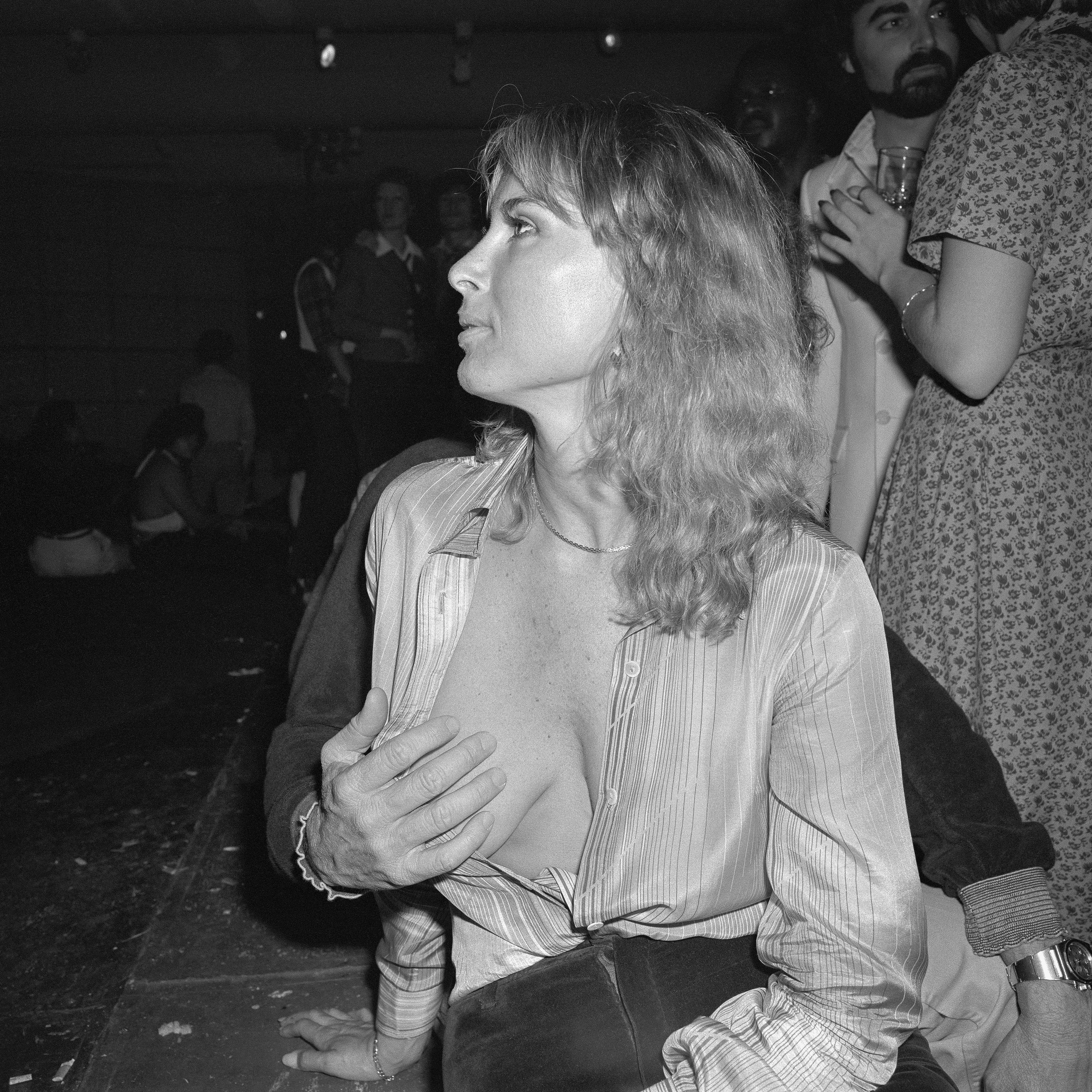 Meryl Meisler was born in 1951 in the Bronx and raised on Long Island, New York. Inspired by Diane Arbus, she enrolled in photography classes at The University of Wisconsin–Madison. Moving to NYC in 1975, she studied with Arbus' mentor Lisette Model, continuing to document life with her quirky eye. While frequenting NY's legendary discos, punk clubs, and Go-Go bars, Meryl captured hedonistic havens, celebrities, and revelers of the night, never revealing the large bodies of unseen work until retiring from her 31-year career as an NYC public school art teacher. Quantum curated this NFT drop from her internationally acclaimed books A Tale of Two Cities Disco Era Bushwick (2014), Purgatory & Paradise SASSY '70s Suburbia & The City (2015), and New York PARADISE LOST Bushwick Era Disco (2021). Imagine pulsating music spinning on vinyl  45RPM as you view these fascinating images encapsulating 1970s nightlife.

Meryl's exhibits include Brooklyn Museum, Annenberg Space for Photography, Dia Art Foundation, MASS MoCA, Islip Art Museum, Center for Photography at Woodstock, New Museum for Contemporary Art, LightWork, the Whitney Museum, galleries in NYC, Paris, and Berlin as well as installations at Grand Central Terminal and throughout the NYC subway system. Her first solo museum exhibition opens in May 2023 at the Zillman Museum. A recipient of numerous awards and fellowships, Meryl continues her photographic memoir begun in 1973 – a uniquely American story, sweet and sassy with a pinch of mystery. CLAMP represents her work.

Hurrah, NY, NY
March 1978
