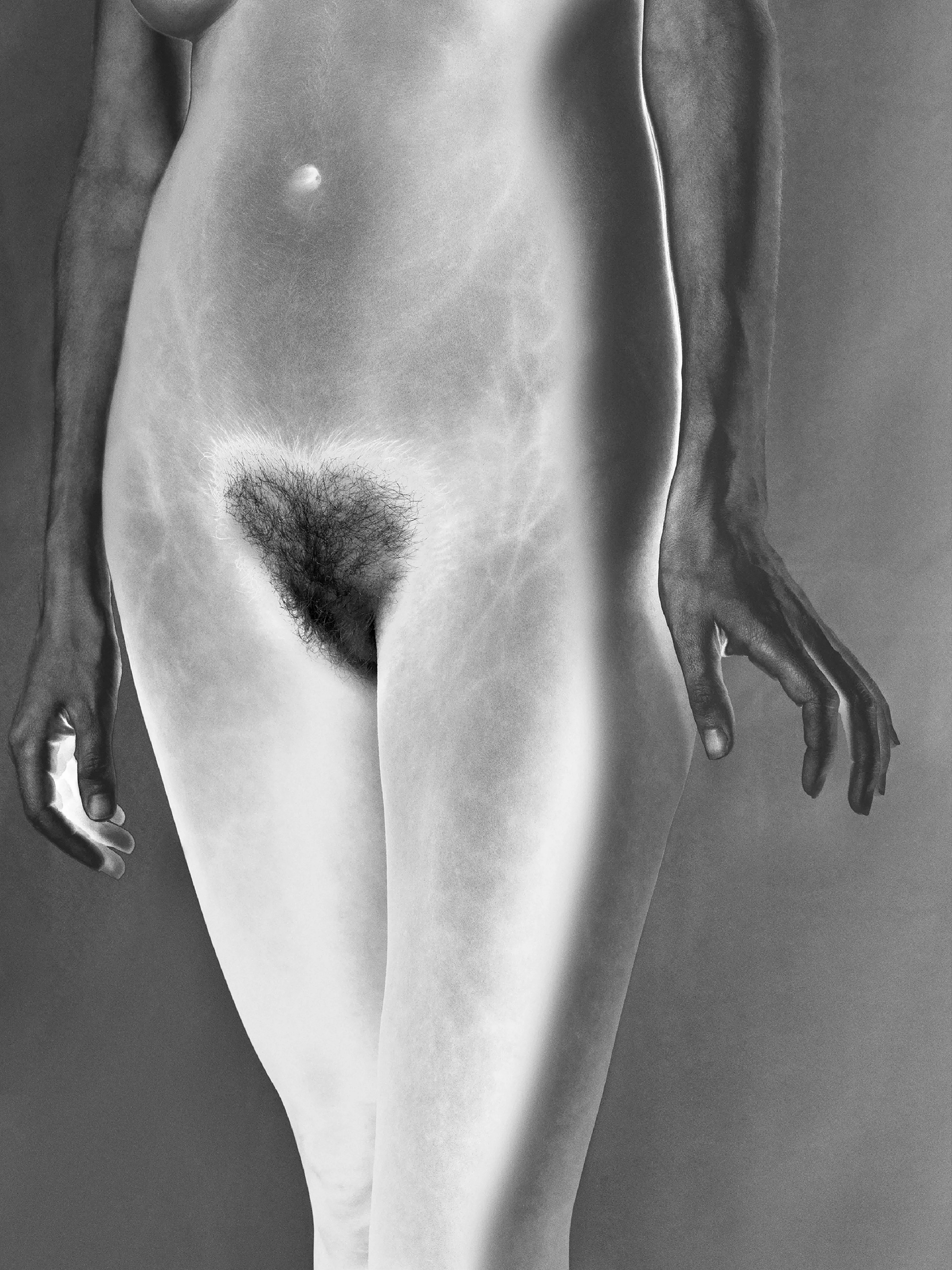 Bushes & Succulents is Mona Kuhn’s celebration of the female essence - confident, raw and elegant, yet confrontational and unapologetic. She returned to the darkroom for the very first reason she fell in love with photography: the latent image. Inspired by the 1920s photo-surrealists, Kuhn explores the ethereal quality of solarization, a darkroom process that unites photography with sketching, in which the subject seems drawn by the alchemist's pencil, resulting in prints with layers of oxidized silver glow in the form of crystalized magic. 

Reminiscent of Georgia O’Keefe’s floral paintings, your eyes wander around the graceful lines, not knowing exactly what you are looking at.  The solarisation process reveals human imperfections, not only in the metallic brilliance of the skin, but also brings to the surface a woman’s struggles, strengths, and power.

“The frame reminded me of early childhood, at age eight or so, when I would jump in the shower with my mother. It resonates an adoration and child-like curiosity for what it is to be a woman. My intention is not to objectify the body, but to celebrate the female body and its essence.

It was crucial for me to collaborate with women of various ages, ethnic backgrounds and body shapes. I wanted to embrace their beauty, their gracious moves, as well as their skin marks and signs of life. My intention is to bring them all together, to unify, just like Gwendolyn Brook's poem, which emphasizes the word "we". The power and beauty of my work lies in the confidence and naturalness of the people I photographed.” - Mona Kuhn

#7