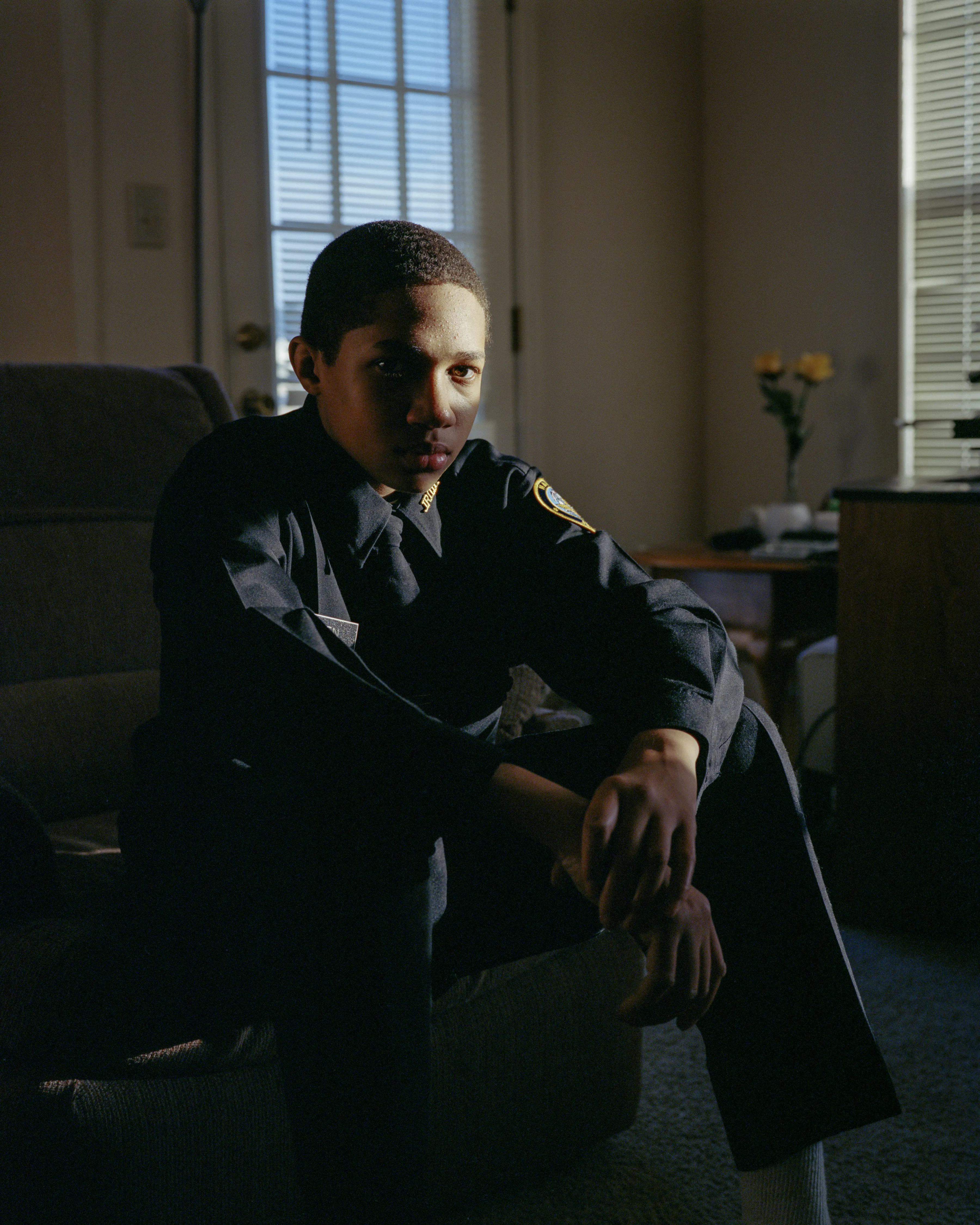 Right before I made the first image of Sharrod, when he went to his bedroom to change, his mother turned to me and said, “Whenever he puts on his uniform, I no longer see my son.”

In the winter of 2008 I met Sharrod, who was in his first year of high school and had recently enrolled in National Junior Reserve Officer’s Training Corps (NJROTC), a military preparatory program offered in high schools nationwide. After explaining my connection to the military and that I was an alum of the same high school that both Sharrod and his mother attended, I asked if I might photograph Sharrod from his freshman to senior year (2008-2012). They both agreed and over the course of the next four years, Sharrod played out his military fantasies for my camera. Sharrod also shared with me the photographs he was making with his cell phone and notebook doodles of weapon construction. These private images and examinations rub up against, color, and compliment the medium format images I’ve made providing the viewer a fuller image of Sharrod’s journey.

Over the course of making the images and video installations for "I slowly watched him disappear," I wondered about the process within which the military body is formed both literally but also psychologically, visually, and emotionally. What is the process of indoctrination and how does the heavy flow of military marketing messages — specifically in military towns— foreclose possibilities for a life beyond the uniform? Furthermore, can one photographically locate the transition from civilian to member of the military unit? 

"I slowly watched him disappear" is the first part of a multimedia “essay” including photographs, video installations, nonfiction films, curatorial projects, and texts which organize my meditations on the fantasy, construction, and deconstruction of the military body and its effects on the broader culture.  