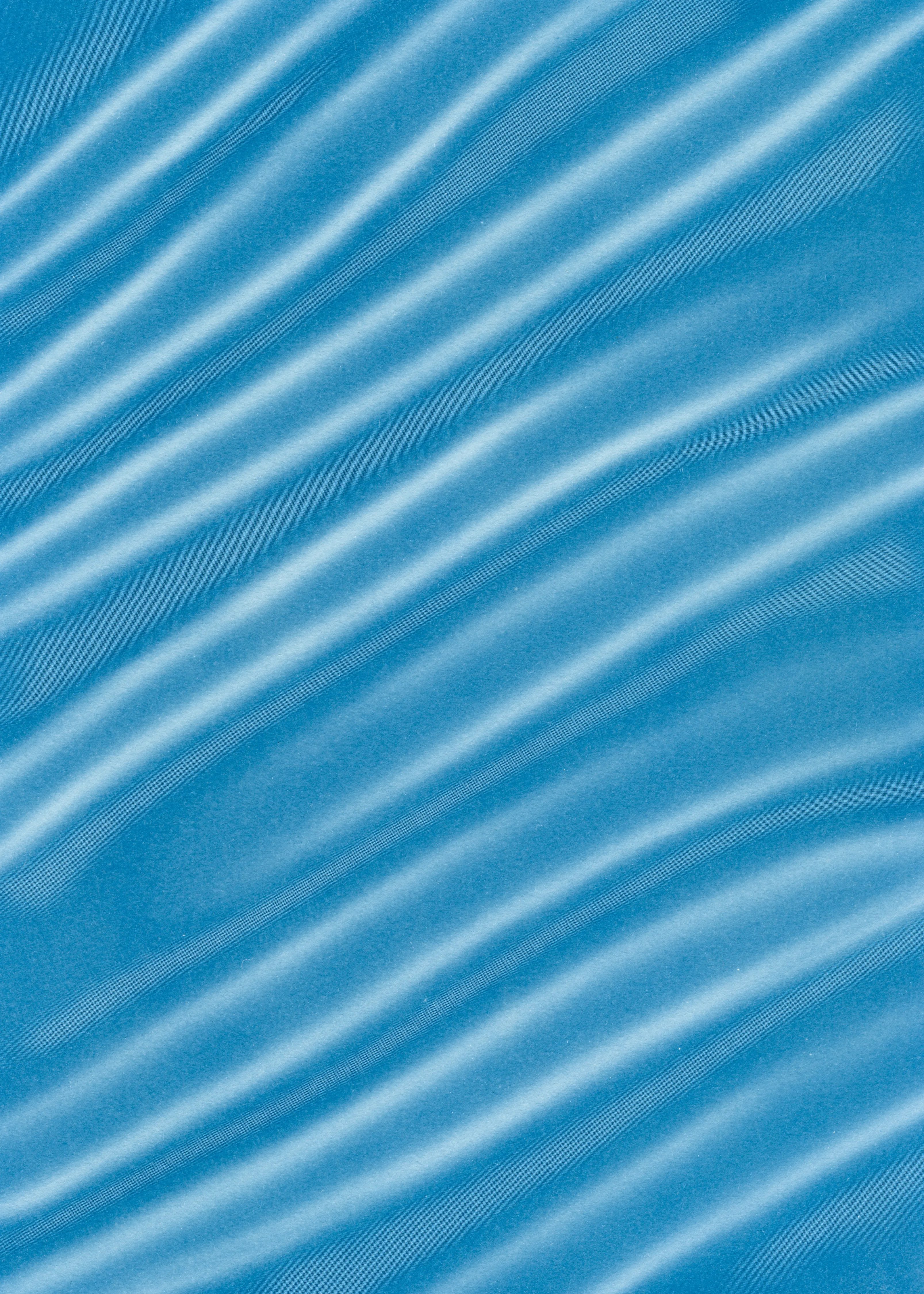 Beyond the Veil is simultaneously a melding of mediums as a means to sculpt with light, and an attempt to
capture the fabric of reality. I work with cyanotype, an alternative photography process that yields blue-
toned impressions when exposed to UV light. 
Cyanotype allows me to interact directly with light, one of the most subtle phenomena we experience day to day. Combined with sculpture, collage and drawing, the
cyanotype process is a powerful creative tool fueled by the sun. Working with light and shadow is to
become aware of how they describe our reality.

Created over the past eight months, this collection has been my safe haven from the world. A finger on the
pulse of something deeper than the chaotic rhythm of daily life, an album of captive sunlight and
experiences preserved in blue. The stillness of winter sunlight, silent rolling waves, a slow, even breath. I
hope you too can find solace here.