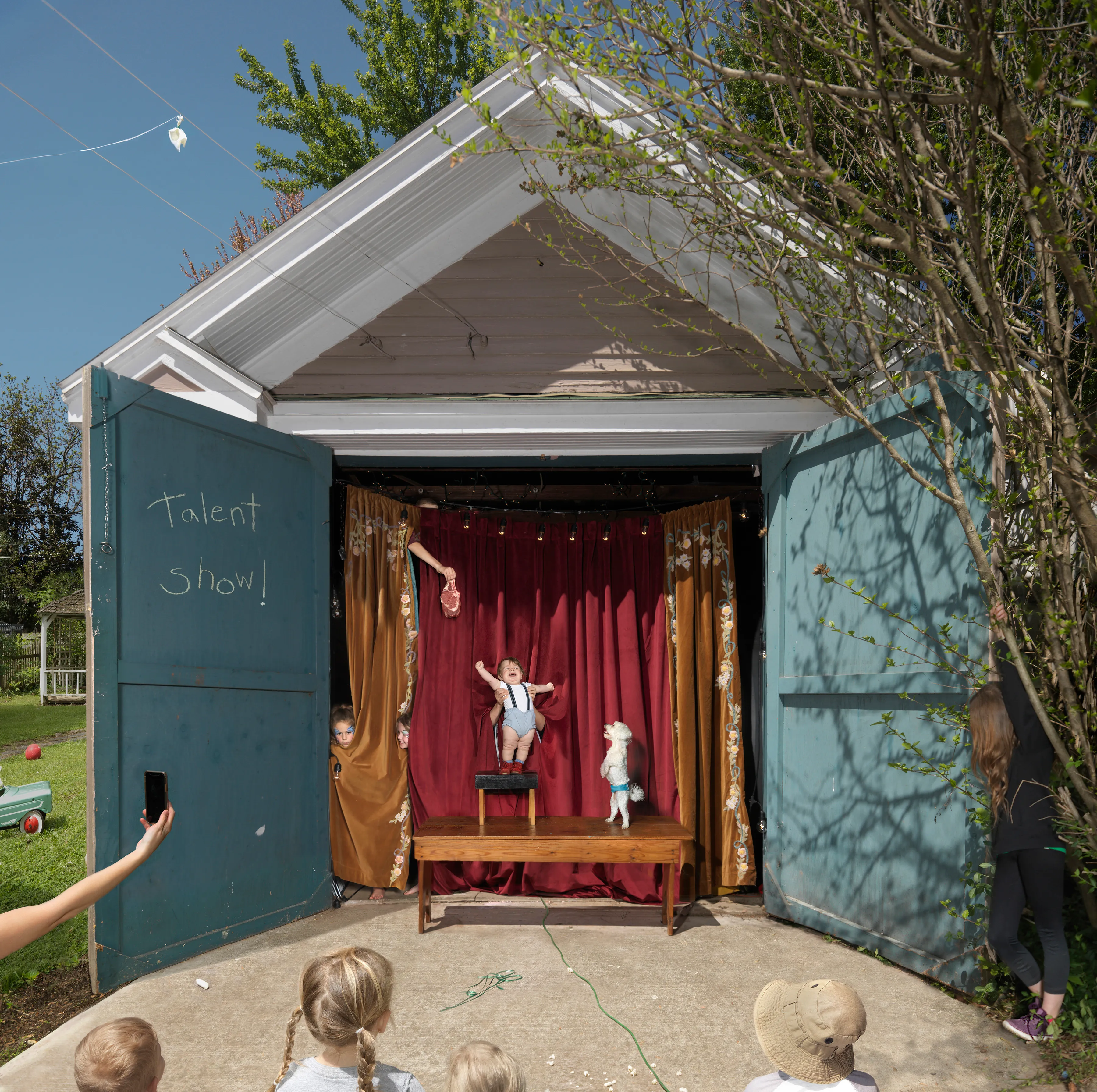 “I suppose I could make a work where the sun is shining, the mom is lying out in the grass, the kids are happy, and everything is perfect, but that wouldn’t interest me—and it wouldn’t be truthful. My aim is to create a more nuanced, subtly humorous and satirical portrait of the way we live today.” - Julie Blackmon

The playfully artful and chaotic elements present in the photographs of Julie Blackmon (American, b. 1966) are drawn from the everyday people and places of Blackmon’s daily routine in her hometown of Springfield, Missouri, which she describes as “a generic American town in the middle of the United States.” At first glance, the works may conjure backyard paradises of children at play; a closer look reveals children alone in backyards, garages, and neighborhoods, where the absence of adults suggests a looming potential for danger. The images brim with fantasy and subtle satire that capture a delicate balance between the darkness and charm of contemporary American life.

Blackmon carefully sets her scenes, but like film and theater
directors, she is in pursuit of unscripted moments that provoke,
disturb, and challenge the viewer. Some of the images reference
paintings by Dutch masters, French impressionists, and such modern painters as Hopper and Balthus, but they are updated with a satirical, penetrating eye and Blackmon’s belief that artful fiction can capture the truth more memorably than the truth itself.

#41