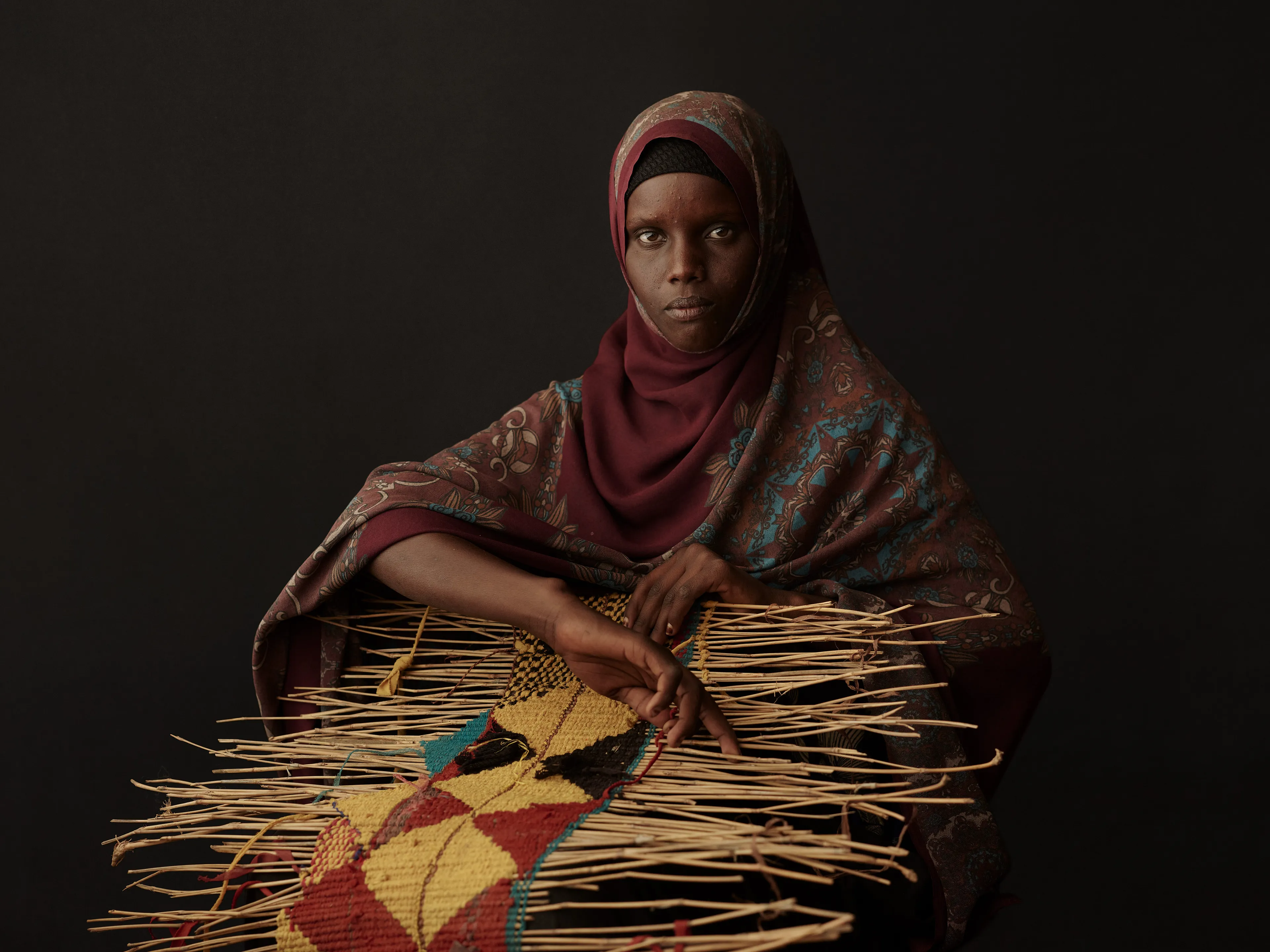 Joey L. returns to Quantum with Ethiopia - Portraits: a collection directly linked to his genesis drop during Season 1. For every environmental image from Joey’s first drop, there is a portrait companion.

“For years, we dragged our nomadic studio tent across almost every region of Ethiopia. In our tent, everyone was equal. We captured pure magic. Every kind of person entered and had their portrait taken. The tent was our little fantasy world. It was the Ethiopia that we dreamed of, even when the reality outside of it was sometimes stricken with searing pain. Each portrait was a tribute to a distinct region of the country. Disconnected cultural threads were woven together in a cohesive visual style in order to truly see Ethiopia— which itself is a modern nation state, but is also the sum of all the diverse people who inhabit it.”

Joey’s portraits alternating on red and black backdrops are the visual backbone of my forthcoming book “Ethiopia” (Insight Editions, January 2023), which compiles 13 years of work.

The tent itself is a metal frame modified with diffusion material made out of netela fabric, which is a hand-spun cotton perfected by Dorze craftspeople. Every portrait is created with natural light molded from the tent itself and photographed on location.

Somali, Jarar, 
Somali Region, Ethiopia
December 2020