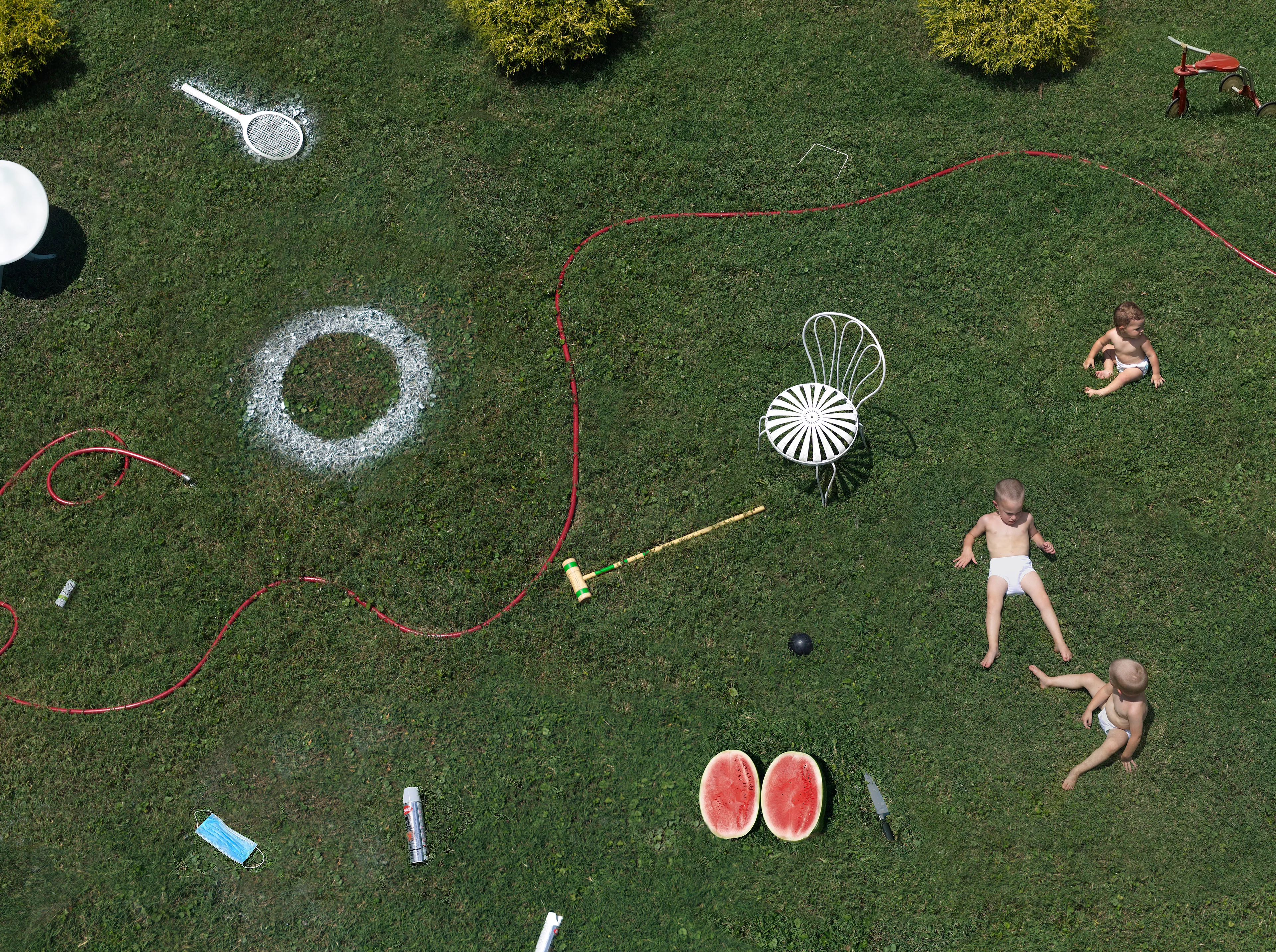 “I suppose I could make a work where the sun is shining, the mom is lying out in the grass, the kids are happy, and everything is perfect, but that wouldn’t interest me—and it wouldn’t be truthful. My aim is to create a more nuanced, subtly humorous and satirical portrait of the way we live today.” - Julie Blackmon

The playfully artful and chaotic elements present in the photographs of Julie Blackmon (American, b. 1966) are drawn from the everyday people and places of Blackmon’s daily routine in her hometown of Springfield, Missouri, which she describes as “a generic American town in the middle of the United States.” At first glance, the works may conjure backyard paradises of children at play; a closer look reveals children alone in backyards, garages, and neighborhoods, where the absence of adults suggests a looming potential for danger. The images brim with fantasy and subtle satire that capture a delicate balance between the darkness and charm of contemporary American life.

Blackmon carefully sets her scenes, but like film and theater
directors, she is in pursuit of unscripted moments that provoke,
disturb, and challenge the viewer. Some of the images reference
paintings by Dutch masters, French impressionists, and such modern painters as Hopper and Balthus, but they are updated with a satirical, penetrating eye and Blackmon’s belief that artful fiction can capture the truth more memorably than the truth itself.

#47