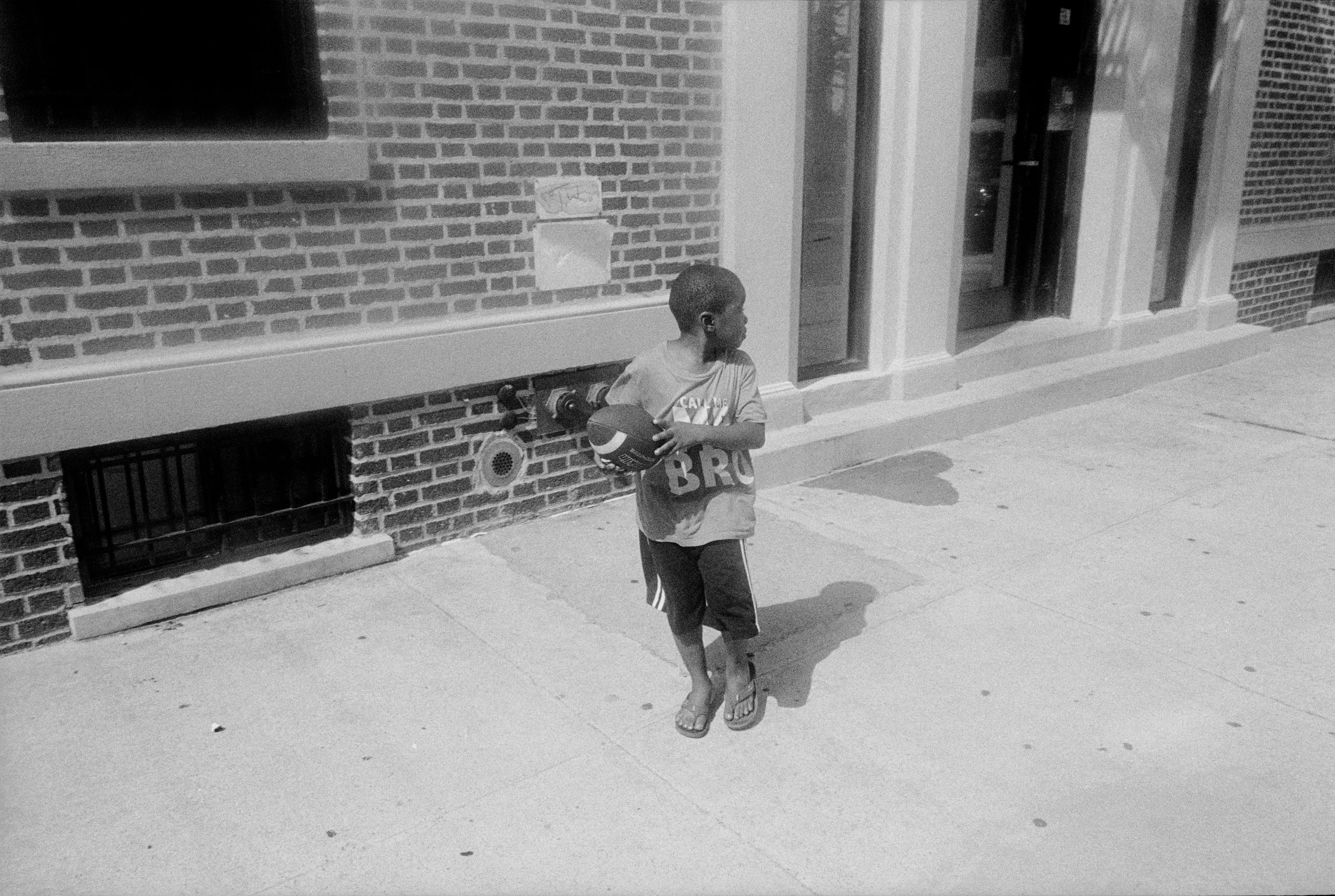 Inspired by the classic observer artists before him (al la Roy DeCarava, Garry Winogrand, and Robert Frank) Laurent Chevalier brings a modern spirit and informed sophistication to this collection of New York City photographs. This collection is a story of New York City, but it is specifically a story of Blackness. Spanning a period of 5 years and punctuated by poetry written by Brooklyn native Dr. Jamila Lysicott, Enough is a tangible exploration of the intersections of the Black experience. Through a lens of candid observation, Enough explores themes of patriotism, power, family and spirit. It does not seek to describe an experience holistically, but rather to present avenues that the viewer may choose and follow at will.

Medium: 35mm black and white negative