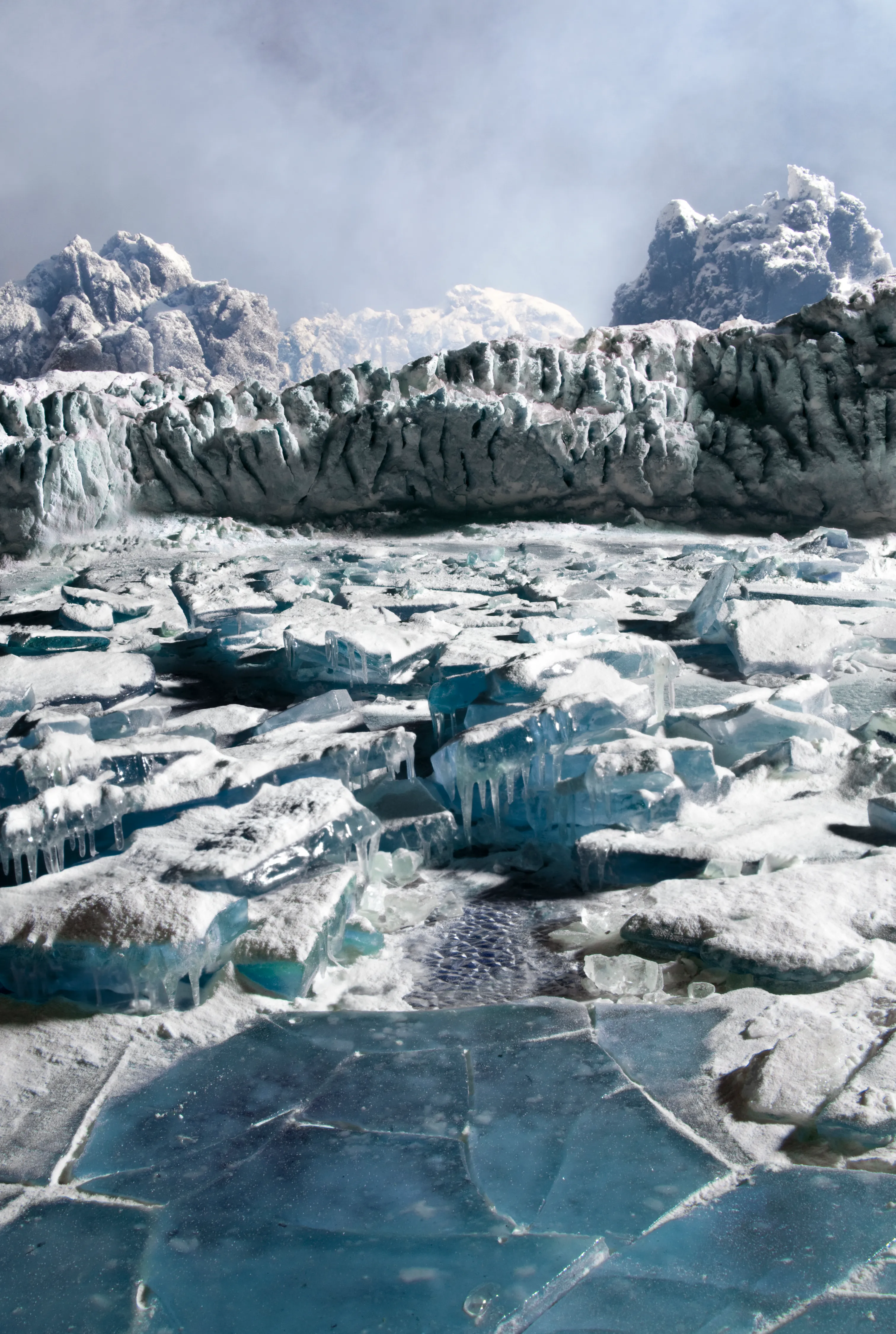 ​From an erupting volcano to a sweeping tornado to the lunar landing, nothing is what it appears to be. Welcome to Matthew Albanese's extraordinary world, where "icy" glaciers are made of sugar, salt, egg whites, food coloring, flour, and light. There is more than what meets the eye in Albanese’s captivating photographs.

Albanese meticulously fabricates and then photographs small-scale models of complex panoramic vistas, such as wind-blown willows on stormy rivers and raging forest fires, using humble materials including cotton batting, boiled sugar candy, sand, and feathers. By manipulating the scale, depth of field, balance, and lighting, he alters the appearance of the materials to create dramatic and emotionally evocative landscapes.