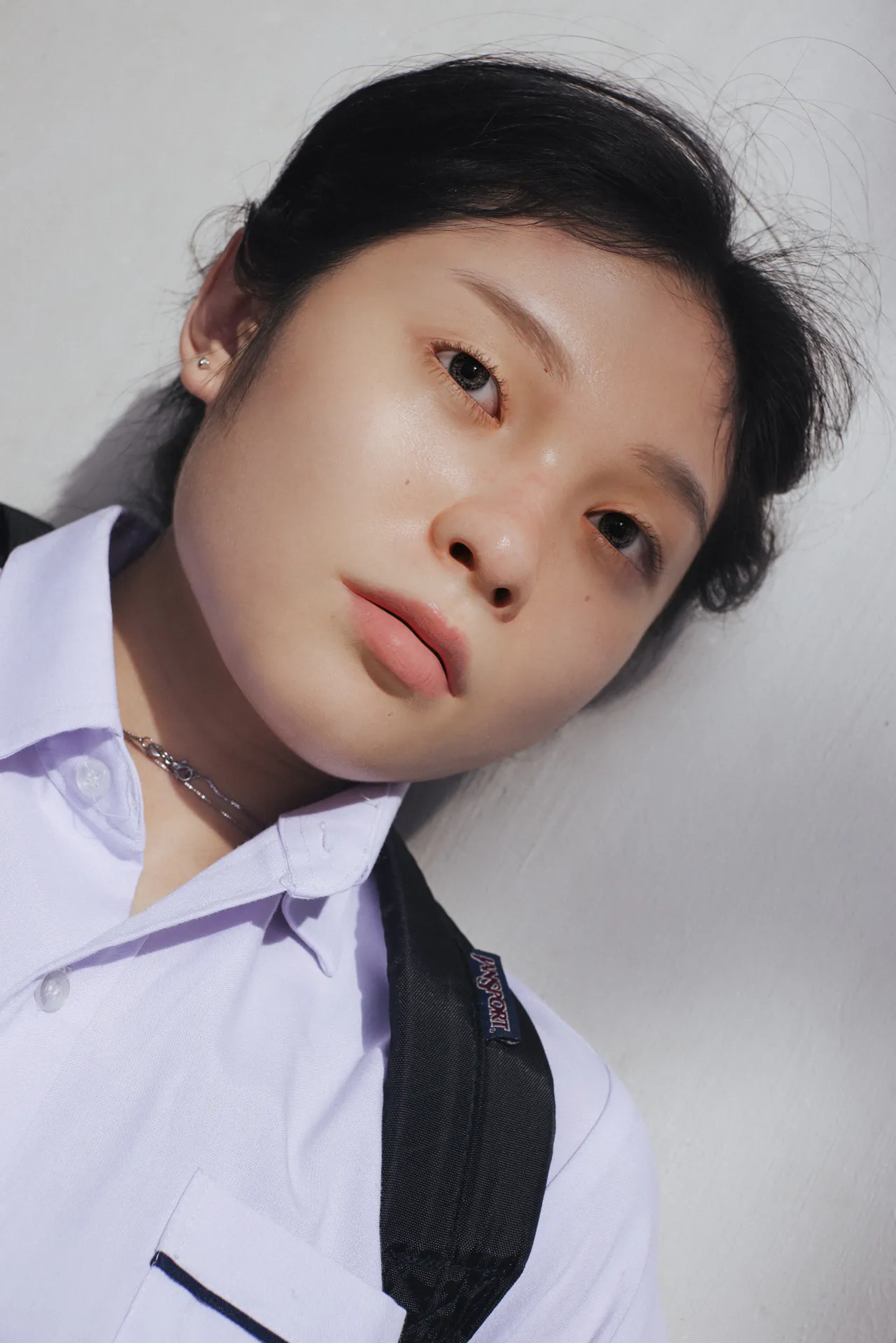 In a world where we take hundreds of photos to document our lives and curate our memories, Singaporean artists and adolescent friends Shavonne Wong and Lenne Chai are examining if memories, just like images, can be easily manipulated to fit our desired version of the truth.
For this project, Shavonne Wong, an award-winning photographer turned 3D virtual model creator, has collaborated with Lenne Chai, an acclaimed US-based Singaporean fashion photographer to create a series of images depicting an imaginary young girl's transition from girlhood to adolescence, sculpted digitally.
This 3D model is an amalgamation of their younger selves, and is inspired by their upbringing in Singapore. Their virtual teenage character hangs out in her bedroom, makes soap bubbles with a friend, takes naps by the sea shore… There is a dream-like quality in the works that underpins an uncanniness to these digitally-crafted realistic pieces.
Echoing a larger trend that questions authenticity in the way we represent and document ourselves, this work takes it a step further to consider the subjectivity of memory. If memories, just like images, can be just as easily manipulated to fit our desired version of truth, then what is real and not?