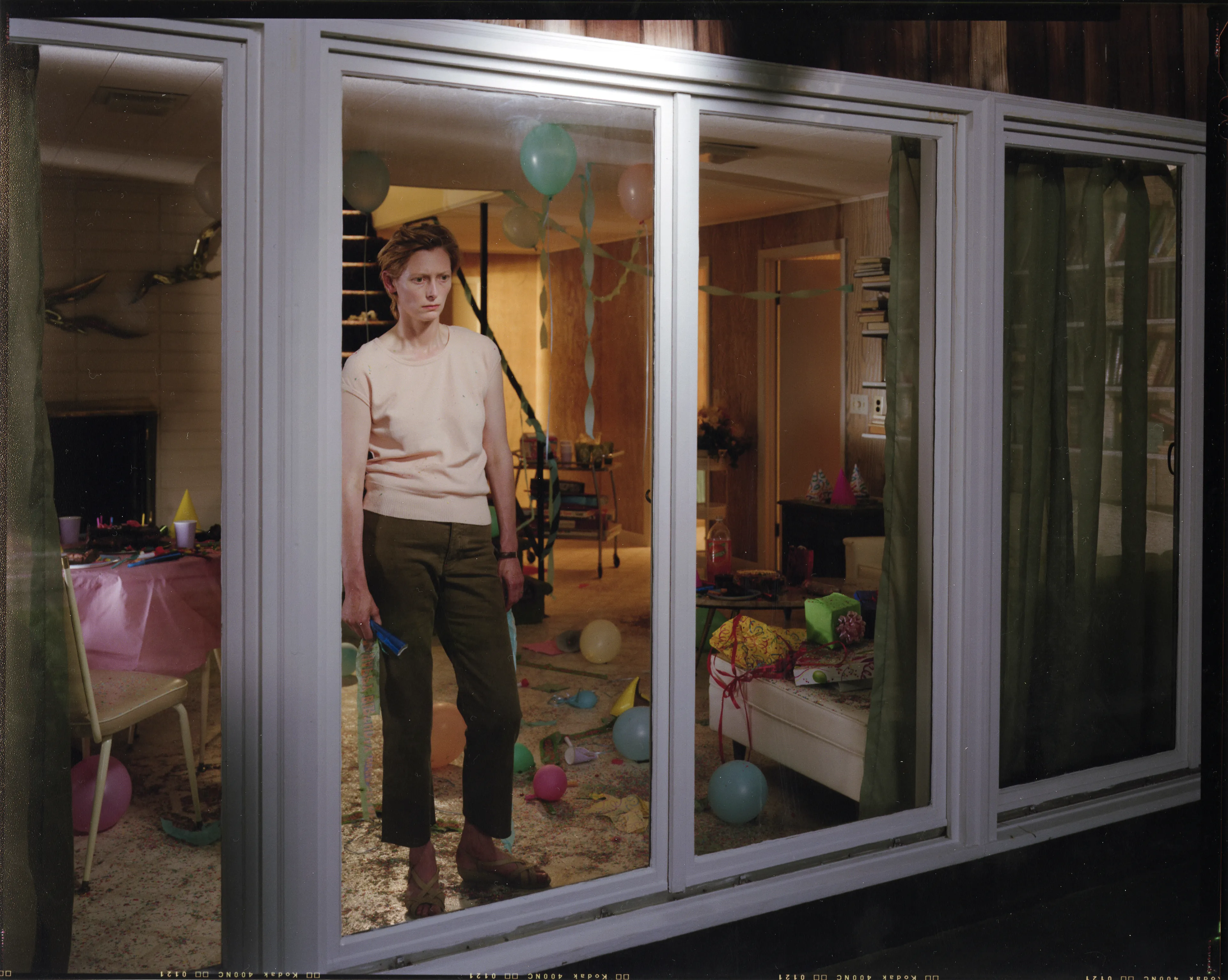 Crewdson’s 2002 project, Dream House peers into the unseen psychological dramas of domestic American life. Focused largely on elaborately staged scenes of home interiors, the twelve images from this portfolio represent frozen moments filled with clues and gestures that suggest underlying narrative sequences that bend ideas of family life into surrealist fantasy. In Dream House, Crewdson nods to the significant influence of cinema over his work by employing actors such as Philip Seymour Hoffman, Tilda Swinton, and Gwyneth Paltrow to stand in as subjects to perform Crewdson’s melodramas in still form. In doing so, Crewdson emphasizes the power of still narrative in relationship to stories told through time, and argues that photographic storytelling can exist as equal in stature to box office films.

Edition: 1 of 1