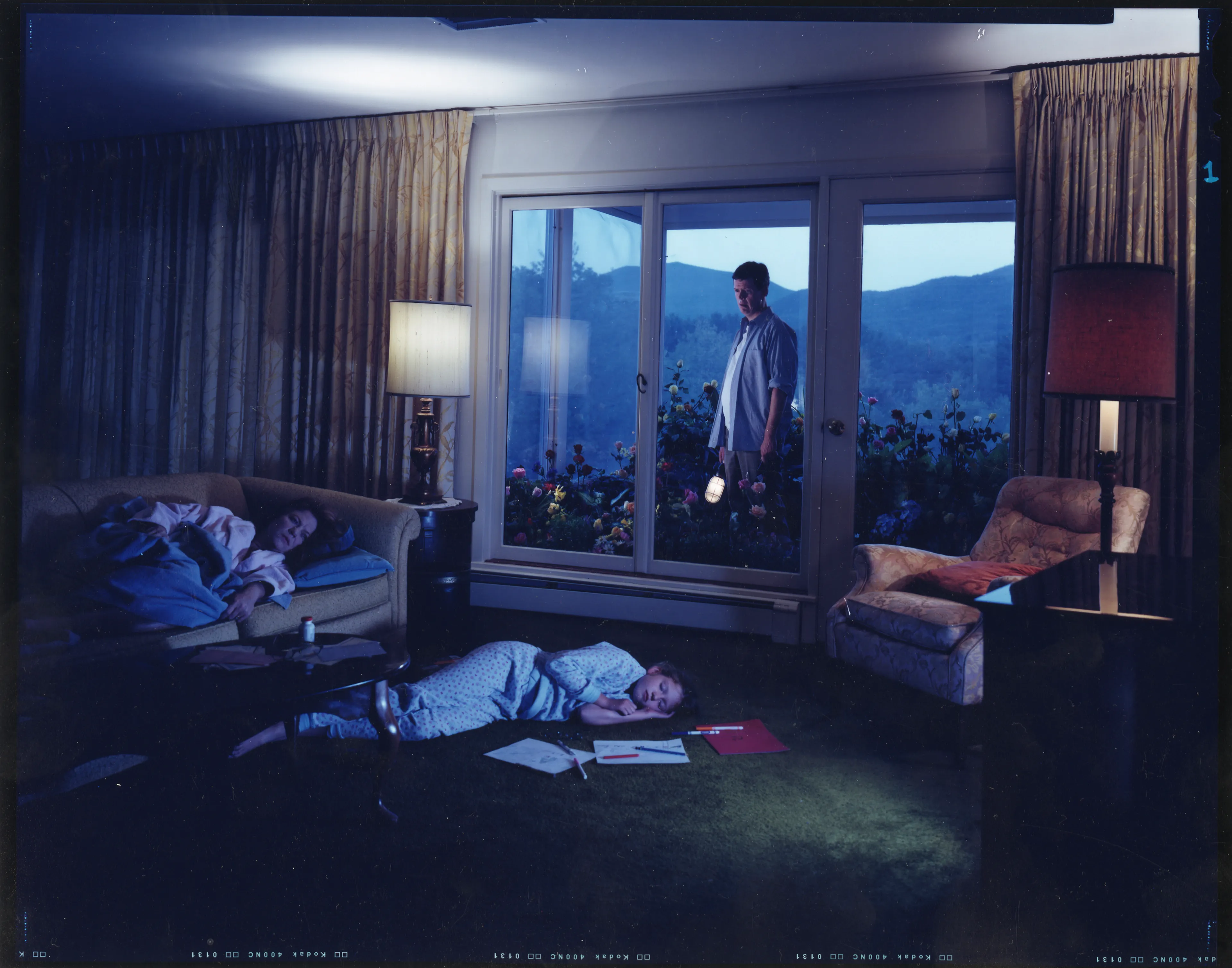 Crewdson’s 2002 project, Dream House peers into the unseen psychological dramas of domestic American life. Focused largely on elaborately staged scenes of home interiors, the twelve images from this portfolio represent frozen moments filled with clues and gestures that suggest underlying narrative sequences that bend ideas of family life into surrealist fantasy. In Dream House, Crewdson nods to the significant influence of cinema over his work by employing actors such as Philip Seymour Hoffman, Tilda Swinton, and Gwyneth Paltrow to stand in as subjects to perform Crewdson’s melodramas in still form. In doing so, Crewdson emphasizes the power of still narrative in relationship to stories told through time, and argues that photographic storytelling can exist as equal in stature to box office films.

Edition: 1 of 1