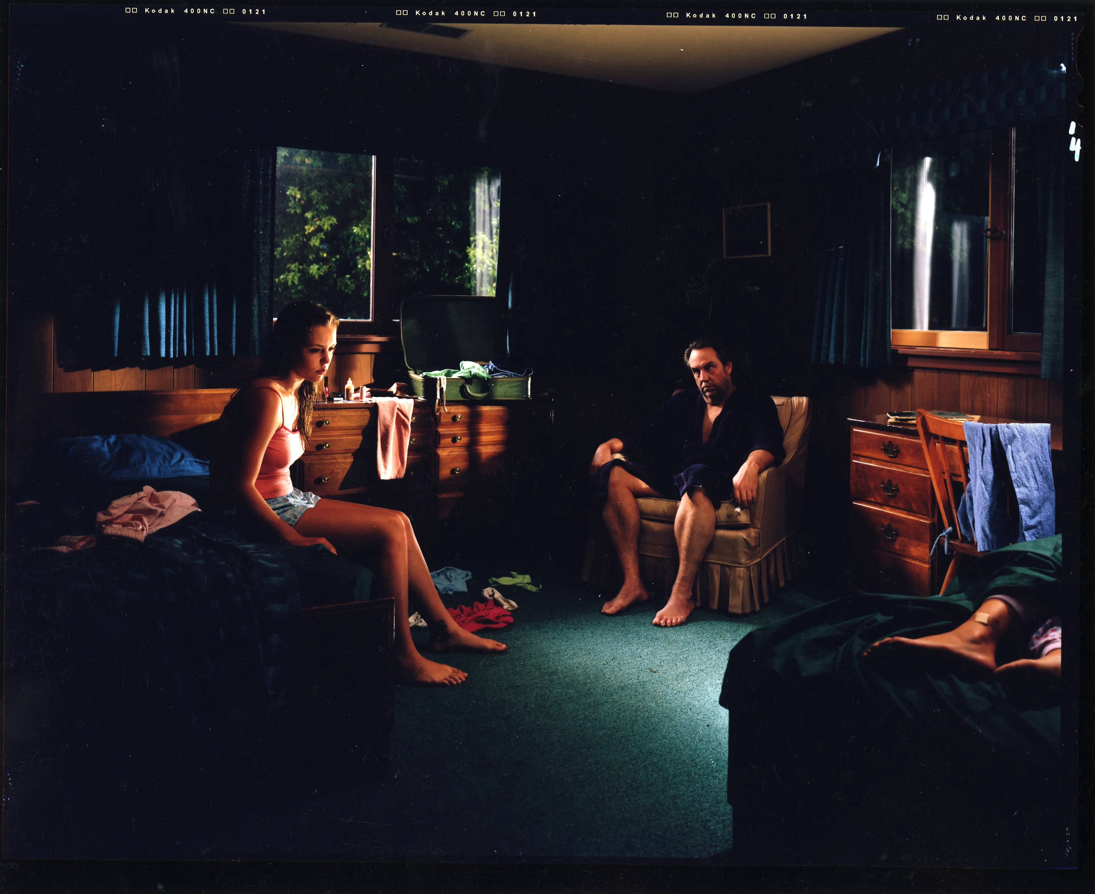 Crewdson’s 2002 project, Dream House peers into the unseen psychological dramas of domestic American life. Focused largely on elaborately staged scenes of home interiors, the twelve images from this portfolio represent frozen moments filled with clues and gestures that suggest underlying narrative sequences that bend ideas of family life into surrealist fantasy. In Dream House, Crewdson nods to the significant influence of cinema over his work by employing actors such as Philip Seymour Hoffman, Tilda Swinton, and Gwyneth Paltrow to stand in as subjects to perform Crewdson’s melodramas in still form. In doing so, Crewdson emphasizes the power of still narrative in relationship to stories told through time, and argues that photographic storytelling can exist as equal in stature to box office films.

Edition: 1 of 1