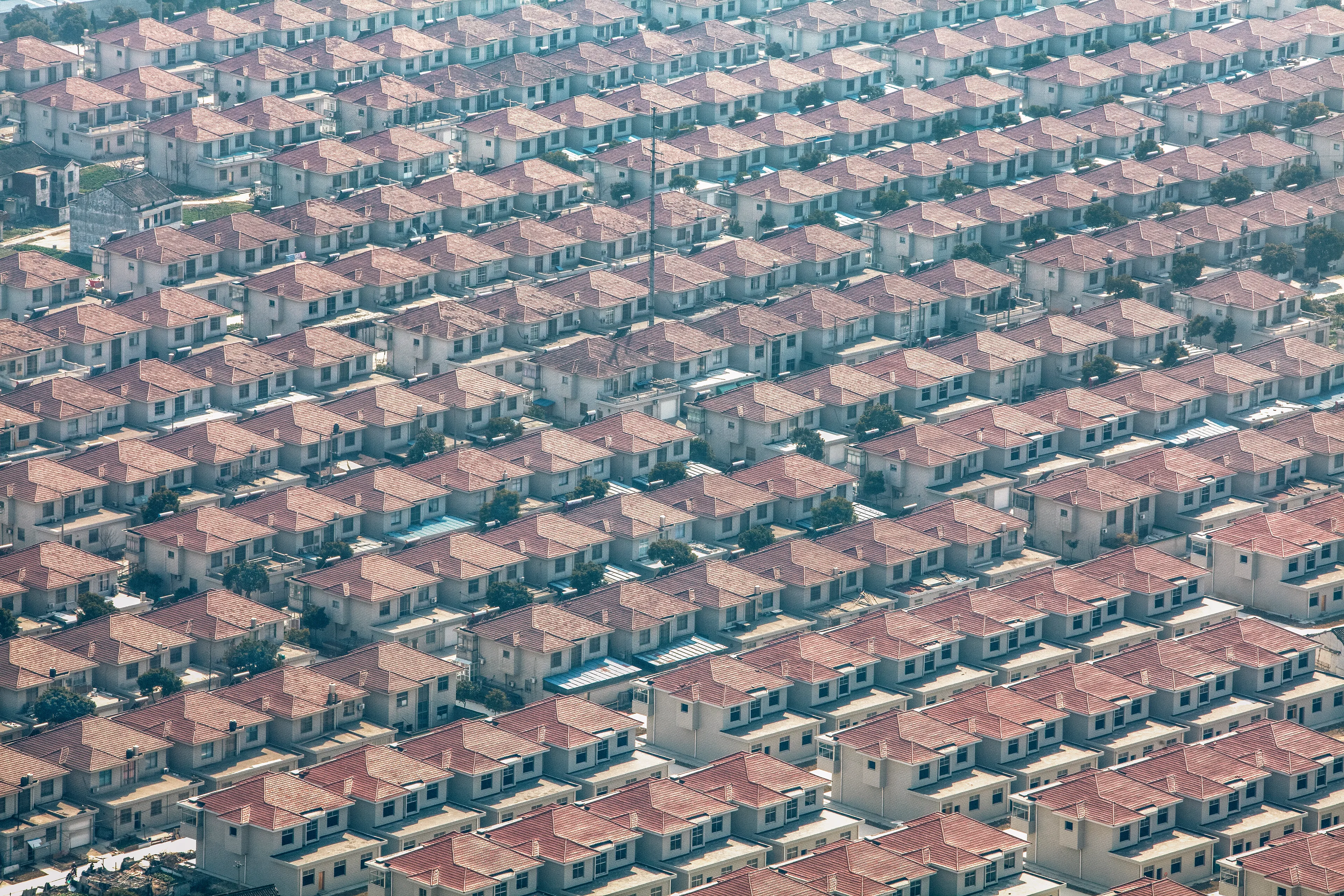 Standardized villas packed side-by-side form the 2,000-member socialist collective of Huaxi Village in rural Eastern China. (by Ryan Koopmans - China, 2012)