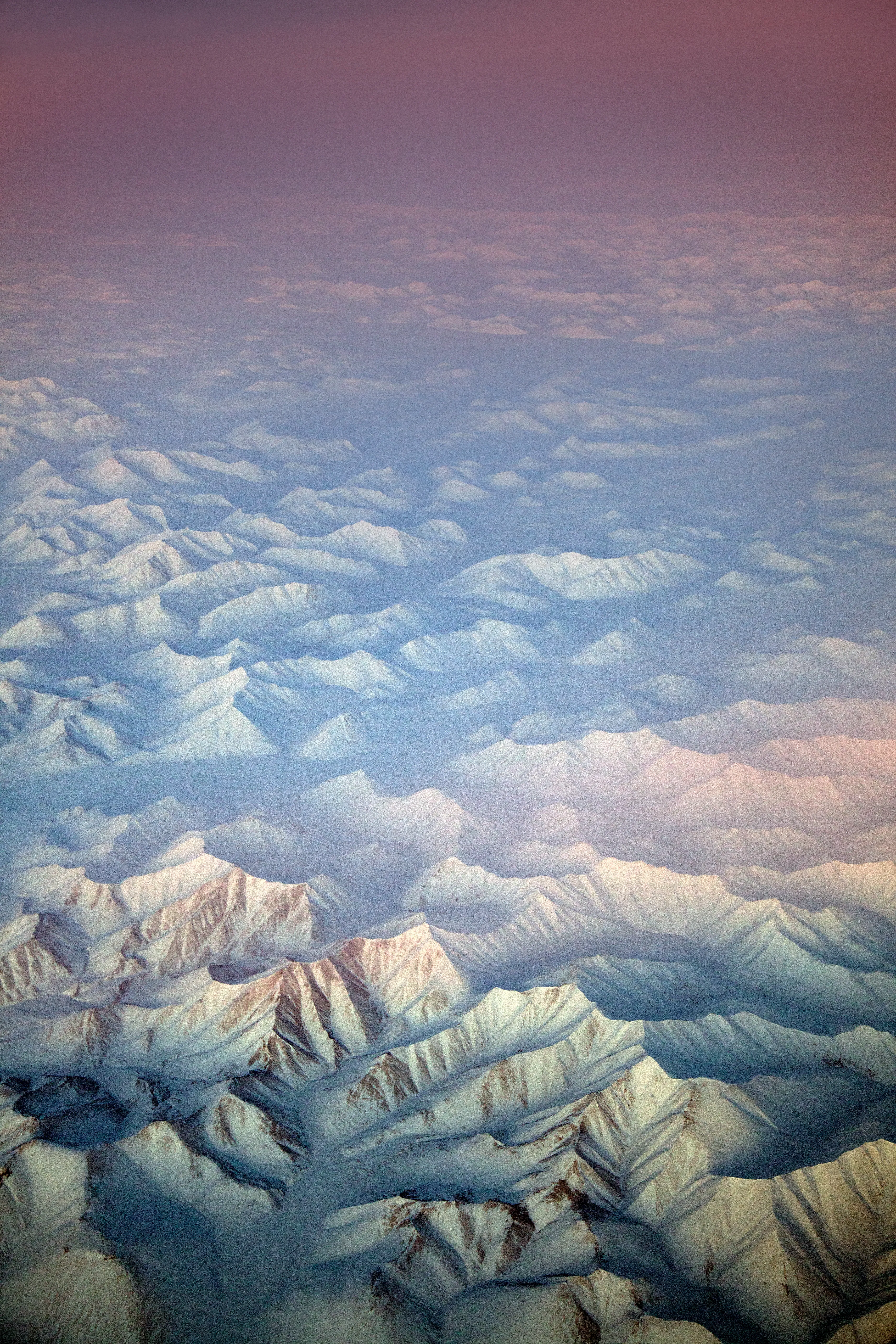 Arctic morning light on a snow-capped Siberian mountain range bordering the Chukchi and Bering Seas. (by Ryan Koopmans - Russia, 2011)