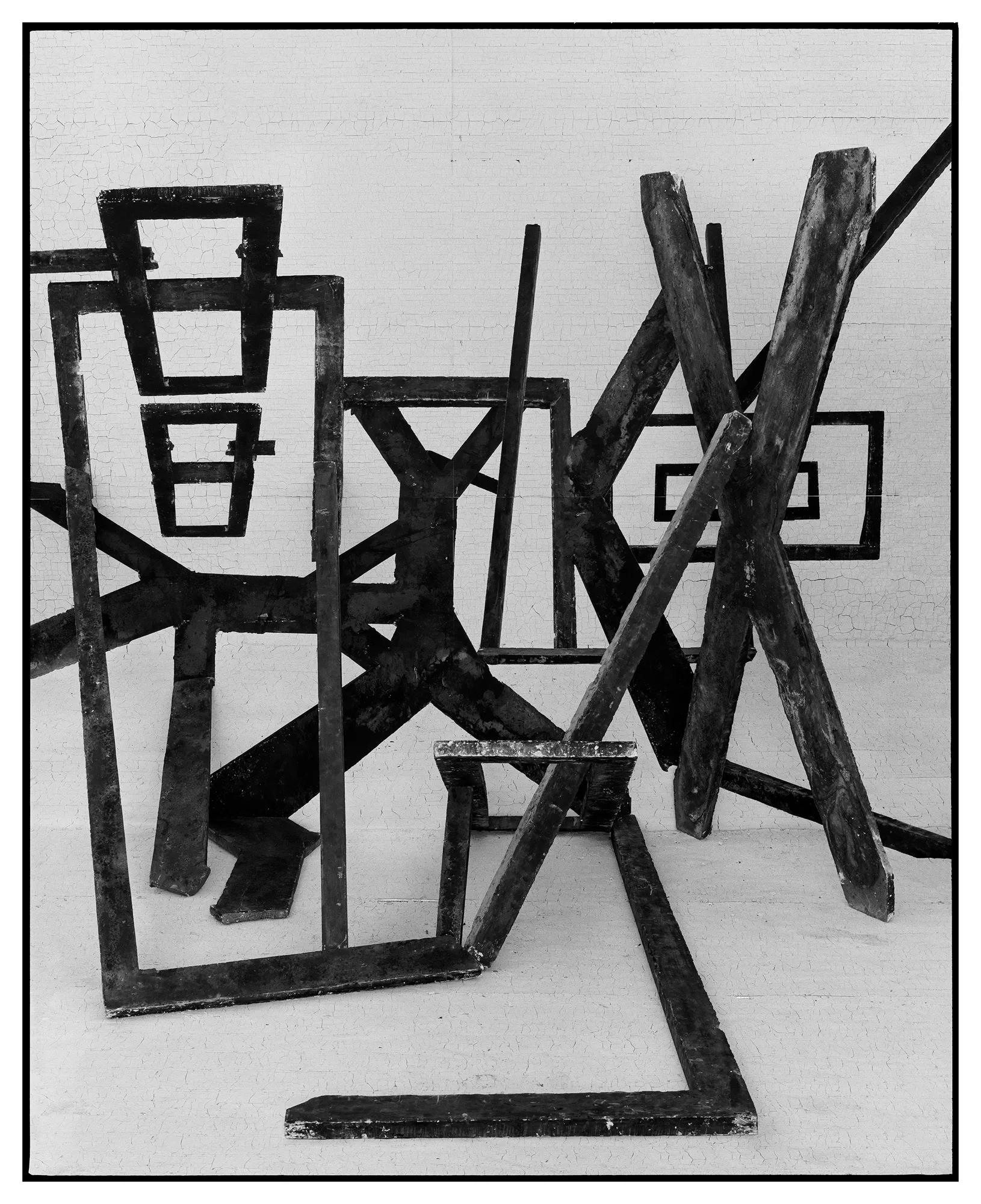 *Constructions* is my first NFT project, weaving together two of my most significant photographic series—*American Type* and *Hedonic Reversal*—as a unique set of 28 images. These architectural constructions, which I make in my studio and then photograph, reference forces of urban construction, destruction, and decay. Devoid of the depictions of labor from which these works were created and of which the work is inherently about, I also critique the ambiguity of post-war American abstraction and art world elitism. These works reference autobiographical threads in order to point to the larger sociopolitical backdrop upon which issues of migration and labor play out.