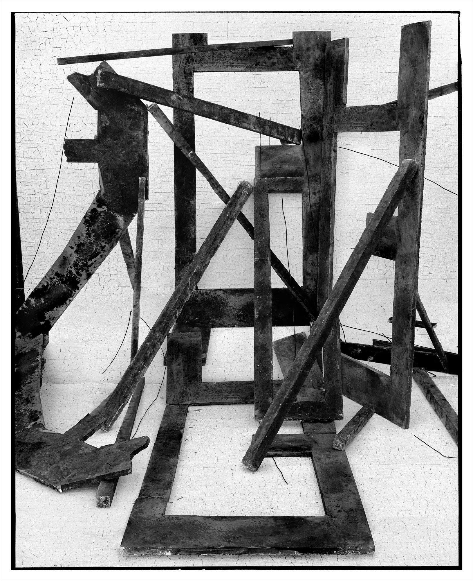 *Constructions* is my first NFT project, weaving together two of my most significant photographic series—*American Type* and *Hedonic Reversal*—as a unique set of 28 images. These architectural constructions, which I make in my studio and then photograph, reference forces of urban construction, destruction, and decay. Devoid of the depictions of labor from which these works were created and of which the work is inherently about, I also critique the ambiguity of post-war American abstraction and art world elitism. These works reference autobiographical threads in order to point to the larger sociopolitical backdrop upon which issues of migration and labor play out.