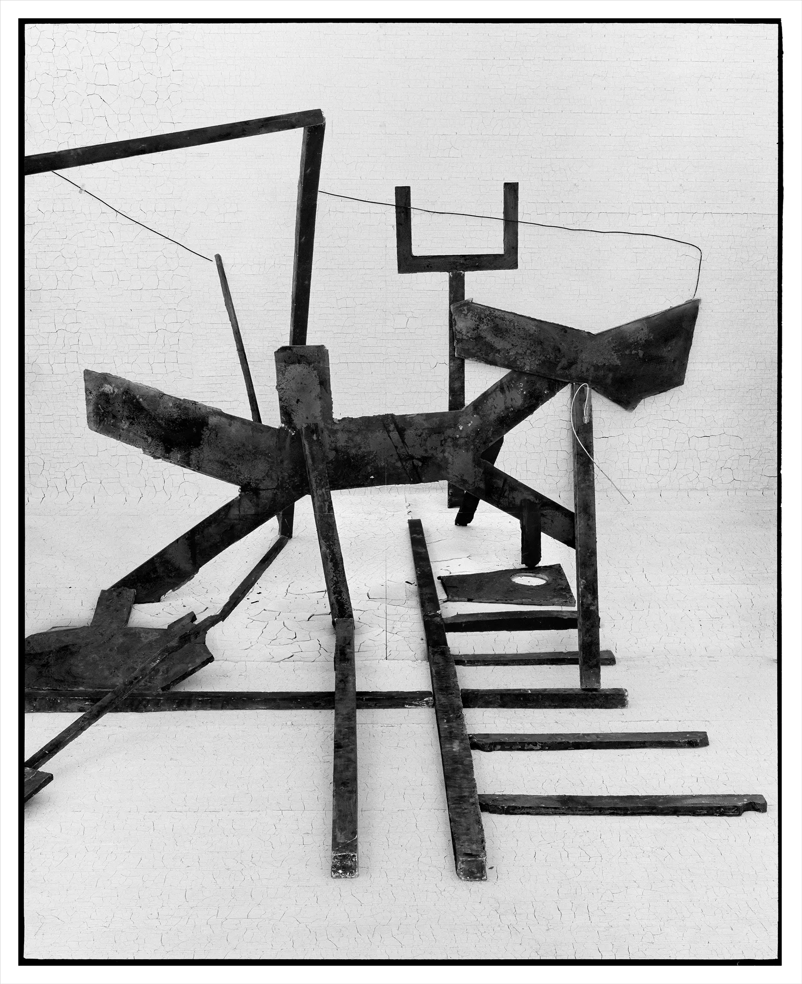 *Constructions* is my first NFT project, weaving together two of my most significant photographic series—*American Type* and *Hedonic Reversal*—as a unique set of 28 images. These architectural constructions, which I make in my studio and then photograph, reference forces of urban construction, destruction, and decay. Devoid of the depictions of labor from which these works were created and of which the work is inherently about, I also critique the ambiguity of post-war American abstraction and art world elitism. These works reference autobiographical threads in order to point to the larger sociopolitical backdrop upon which issues of migration and labor play out.