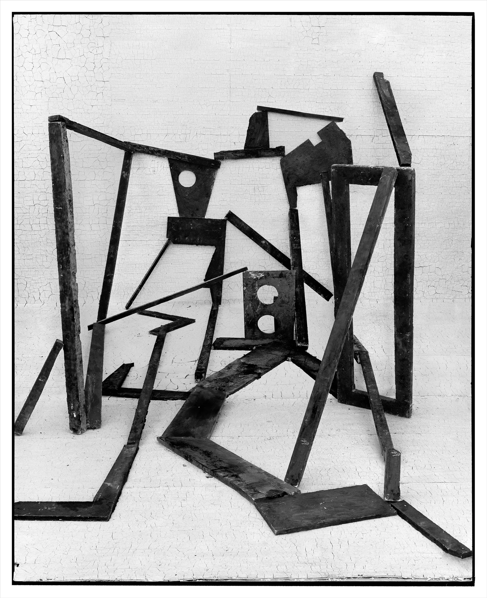 *Constructions* is my first NFT project, weaving together two of my most significant photographic series—*American Type* and *Hedonic Reversal*—as a unique set of 28 images. These architectural constructions, which I make in my studio and then photograph, reference forces of urban construction, destruction, and decay. Devoid of the depictions of labor from which these works were created and of which the work is inherently about, I also critique the ambiguity of post-war American abstraction and art world elitism. These works reference autobiographical threads in order to point to the larger sociopolitical backdrop upon which issues of migration and labor play out.