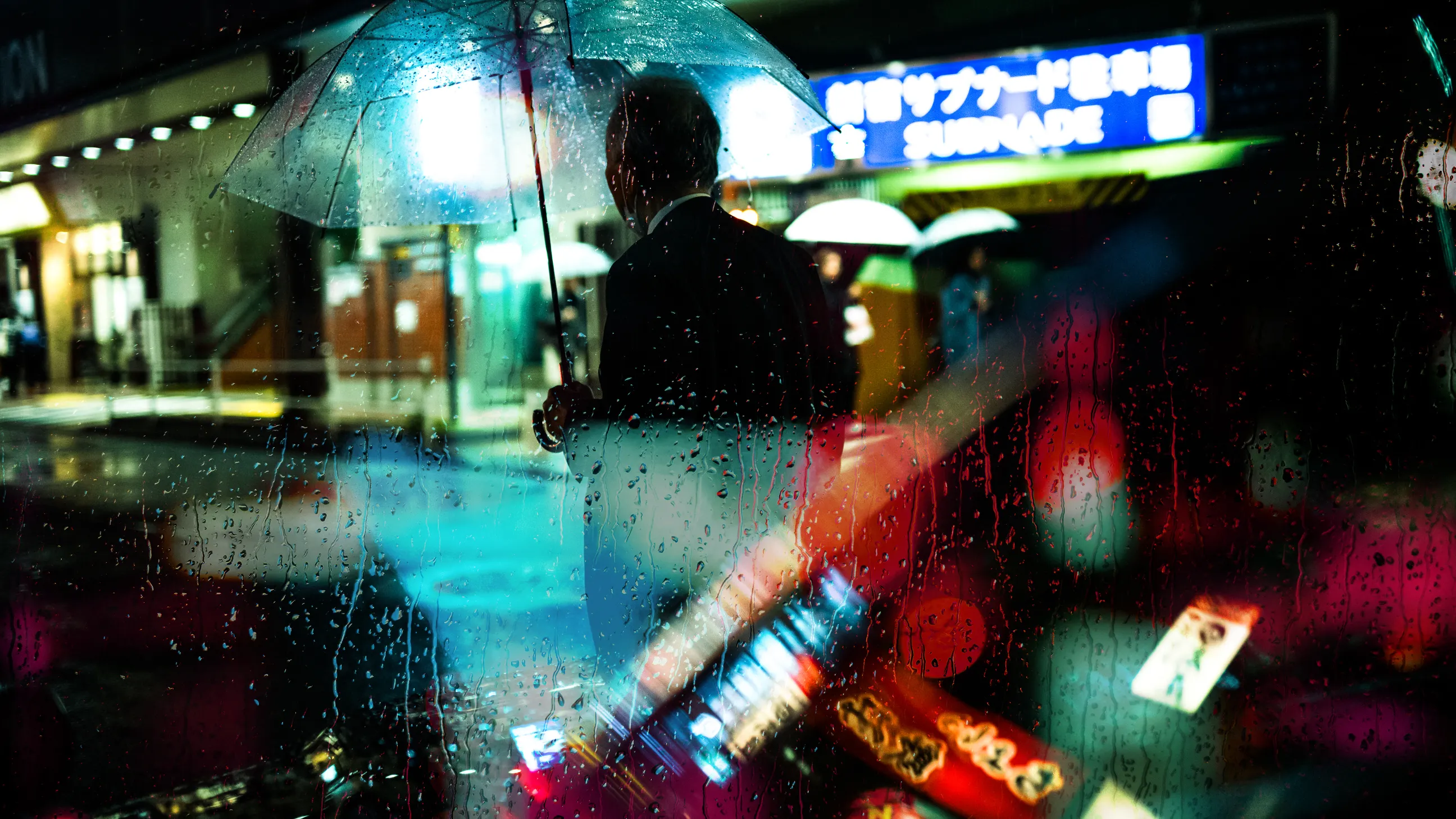 During that night where the rain was painted by the lights there he was, waiting in the hope to see her again come out from the station where they once promised to meet again.

📸 Leica SL & ZEISS 1.4/35
📍 Ryogoku St., Tokyo 2021 
Shot during the COVID-19 pandemic lockdown.
