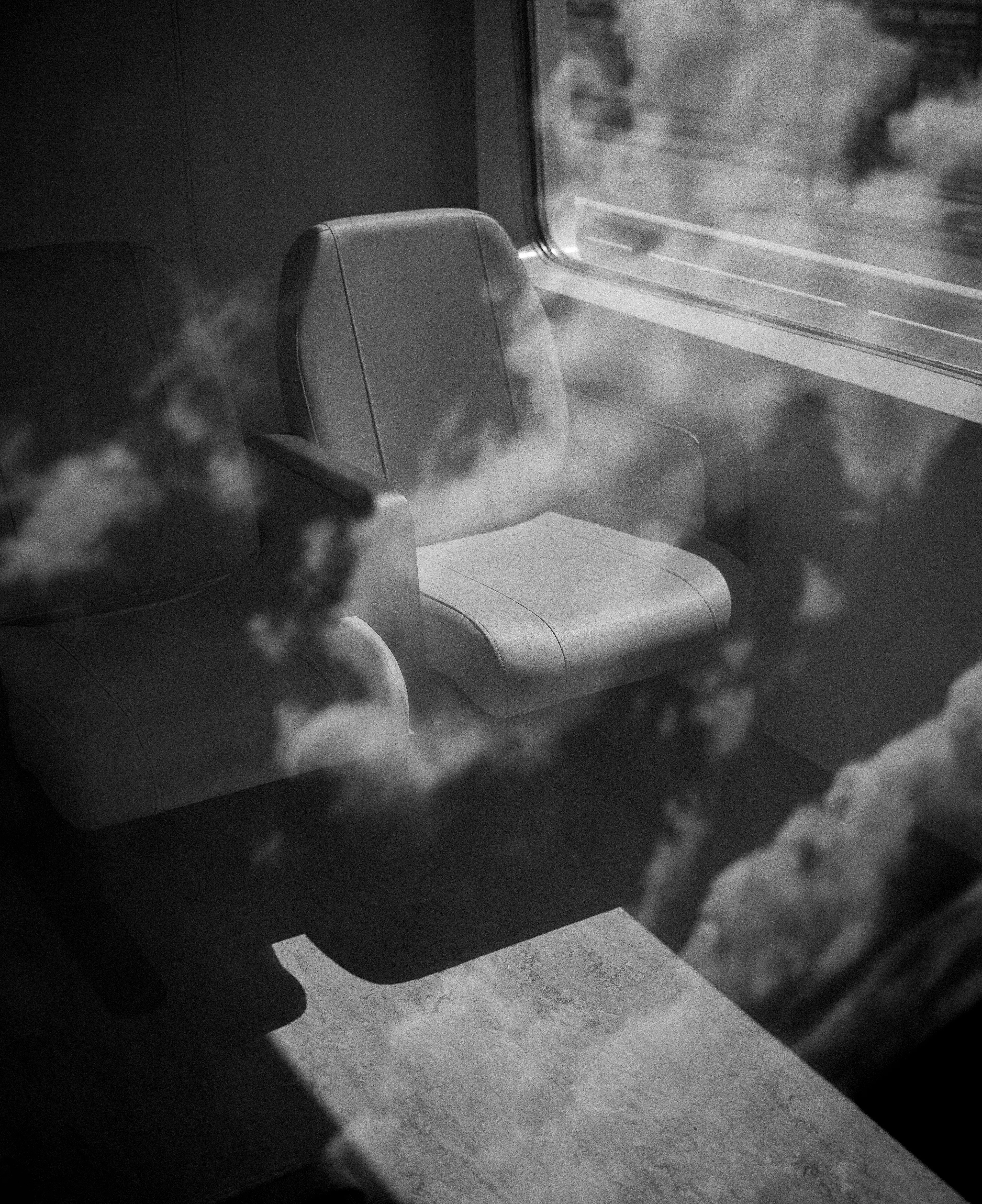 The seats held silence.  
Clouds passed through the glass.