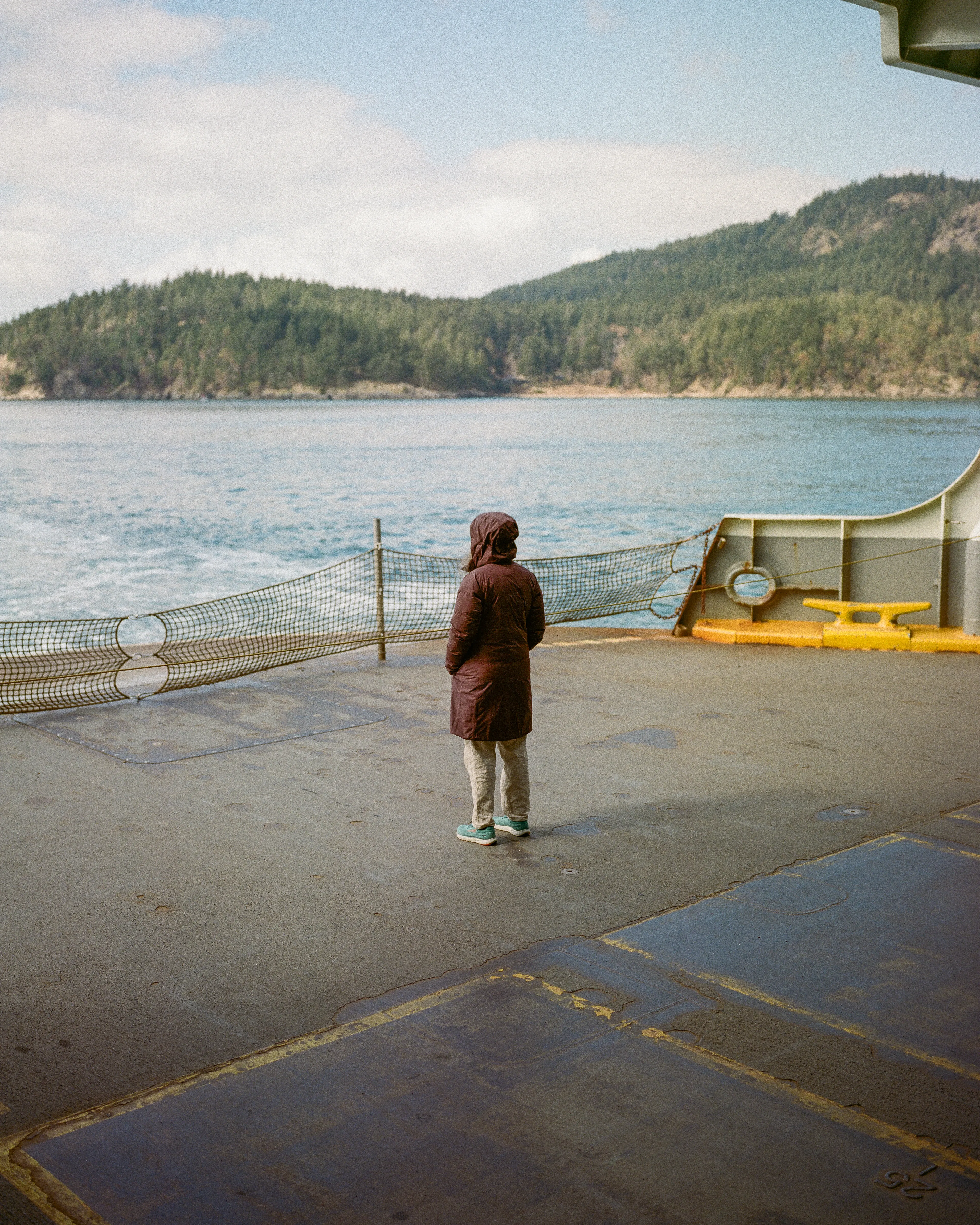 As the ferry was getting closer to reaching it's destination, back to Anacortes from Orcas Island, I decided to head towards the back of the boat to take in the views one last time for the day.

When I got there I found this woman, standing by herself, soaking it all in. The beauty of the water, islands in the distance, in the late afternoon light. 

It's moments like these that I love capturing as a photographer. There's so much we don't know about this woman, and what experience she might be having alone on the back of that ferry. We get to create and apply whatever story we want, without ever knowing the real one.