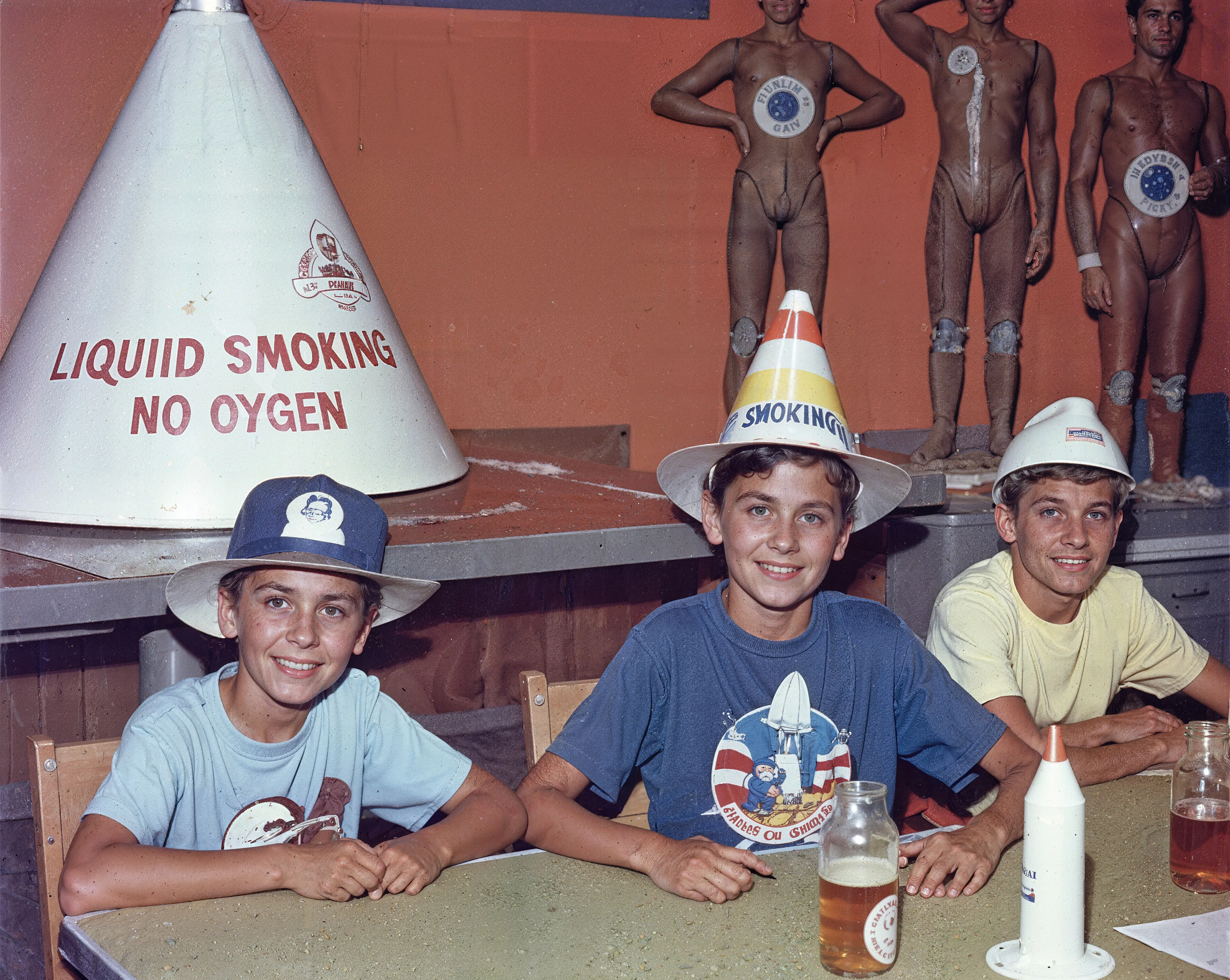 35mm #1: USA, Florida, 1960s - Three kids sitting around a table at a party
35mm #2: USA, Florida, 1960s - Liquid oxygen tank and stationed rocket at the Kennedy Space Center