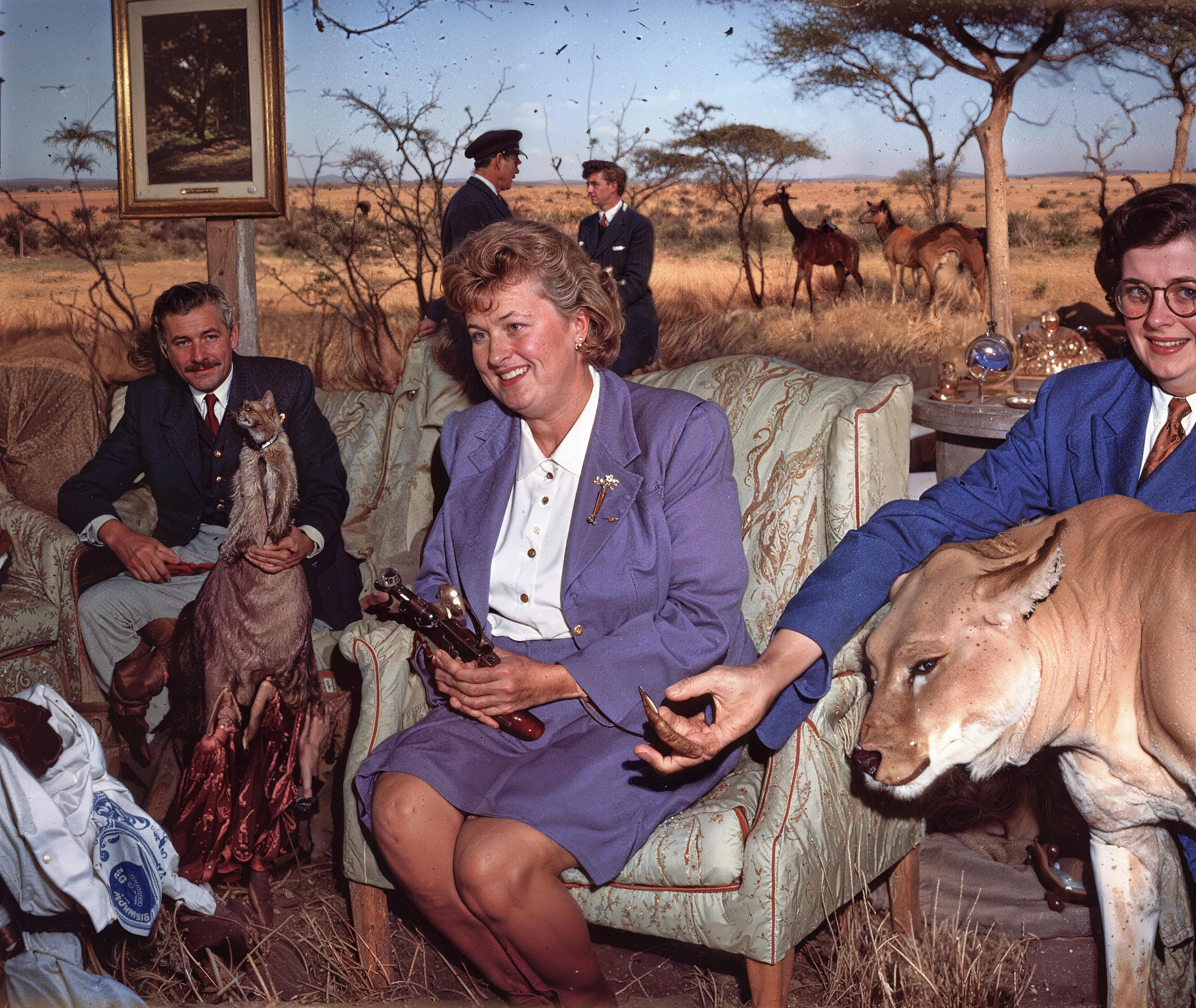 35mm #1: England, Wells, 1960s - Family gathering in living room
35mm #2: Kenya, Maasai Mara National Reserve, 1960s - A hunter and local Maasai people skinning a lion