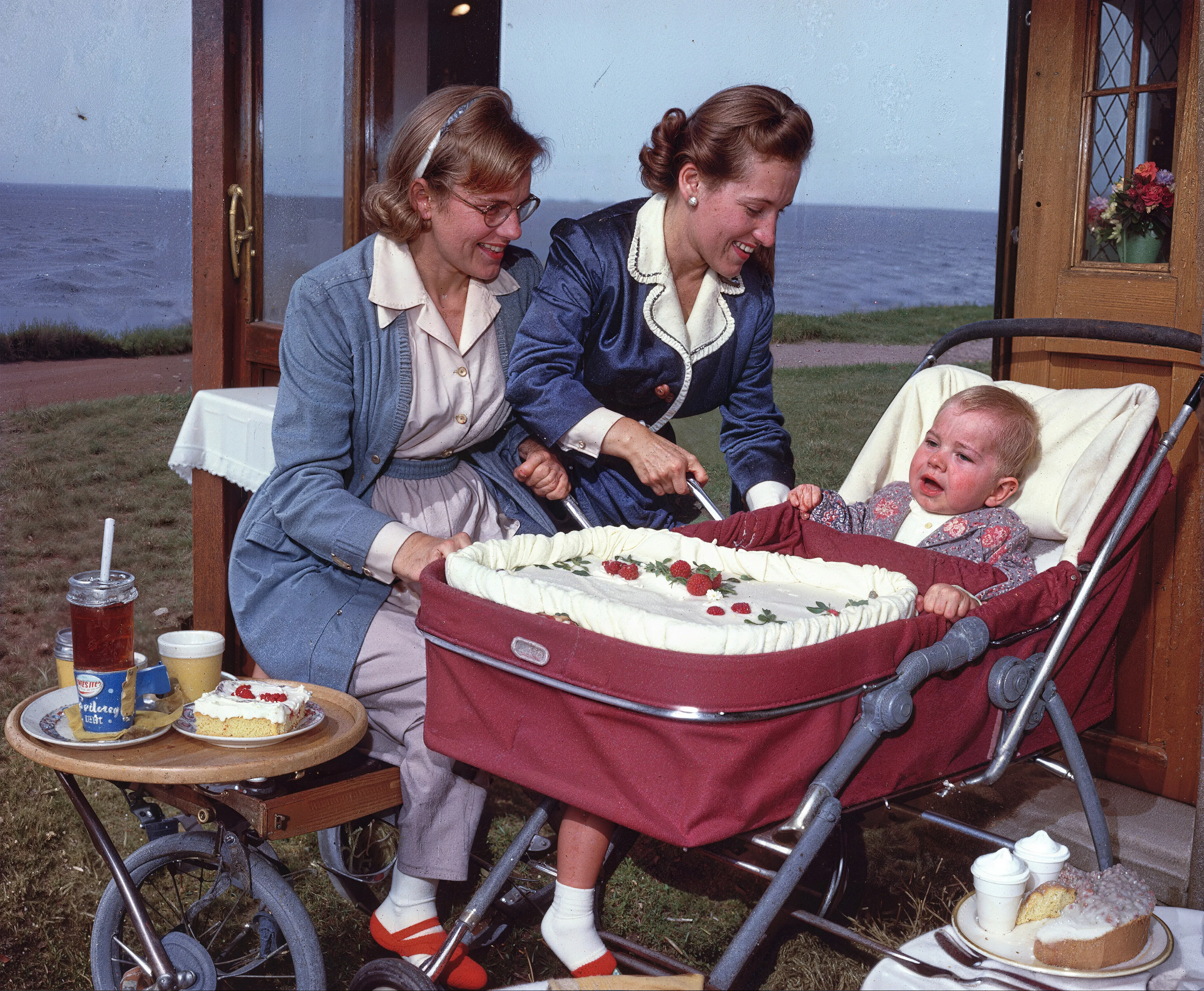 35mm #1: England, 1950s - Child and baby in a pram next to the sea
35mm #2: England, 1970s - Family with a Christmas cake