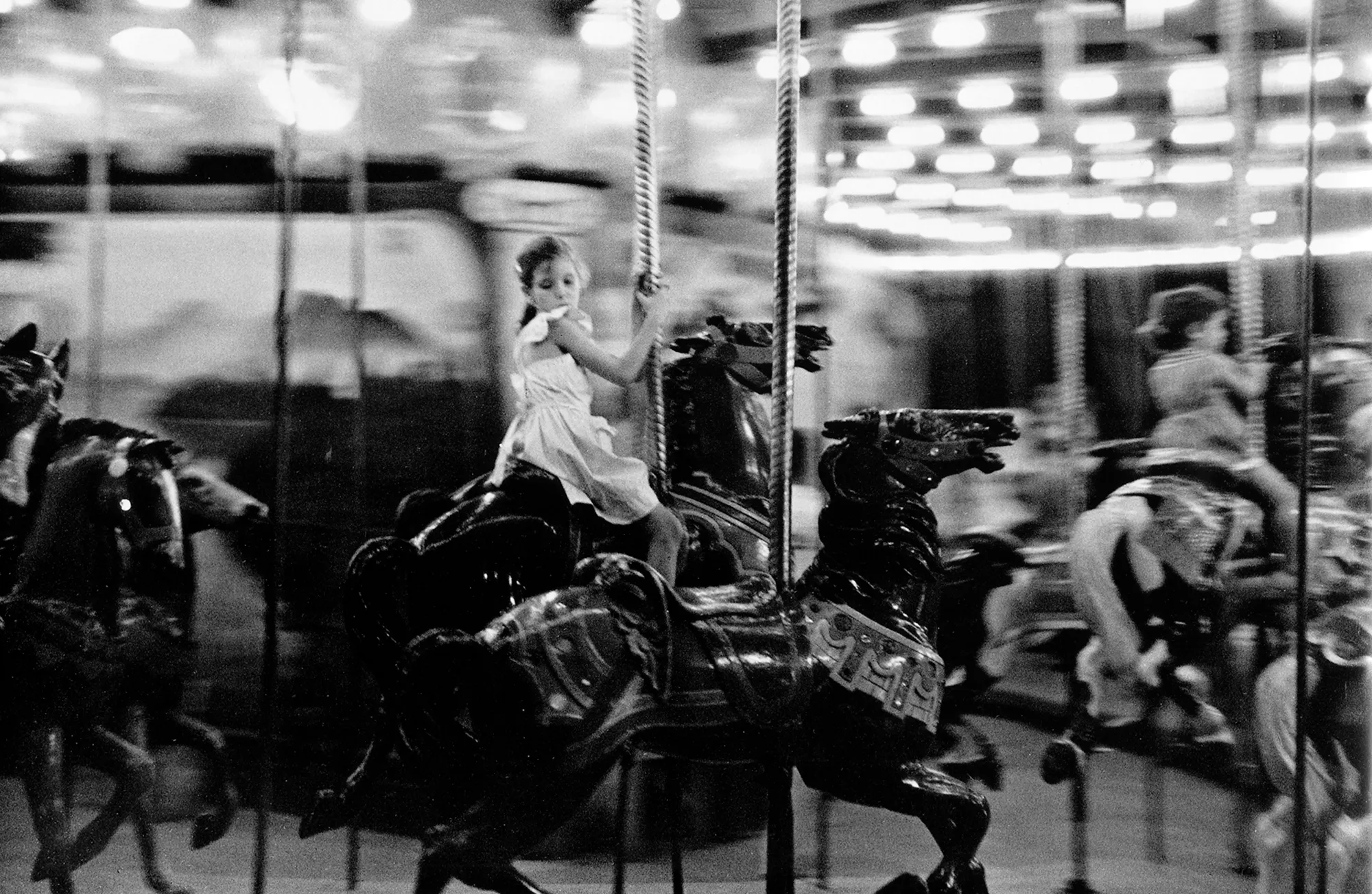 Assembly Curated and Bruce Silverstein Gallery present Frank Paulin’s “Masterworks,” a collection of some of the most iconic early work from the artist’s archive. “Masterworks” features photographs predominantly captured in the 1950s on the streets of New York City. Many of these early images by Paulin were featured in a 1957 solo exhibition at Helen Gee’s pioneering gallery and café, Limelight. Paulin’s work earned him great praise despite photography’s then uninitiated position in the fine art world. Prominent publications including The New York Times and The Village Voice praised Paulin’s ‘humor and compassion’ as well as his uncanny ability to perceive irony and record what they referred to as ‘poetic accidents.’ Paulin was a freelance fashion illustrator by day, but took to the streets in his free time to document subjects from all walks of life set against the stunning visual framework of advertisements, neon signs, and reflective store windows. This collection of well-known work recalls a distinct moment in American history, a moment captured with a passionate vision that keeps us looking.

Rediscovered in his eighth decade, Frank Paulin (b. 1926) is renowned for uniquely documenting fleeting human moments of humor and poetry, often against the backdrop of gritty urban scenes. His iconic work is in numerous collections including the MoMA, the Whitney Museum of American Art, and Yale University Art Gallery.