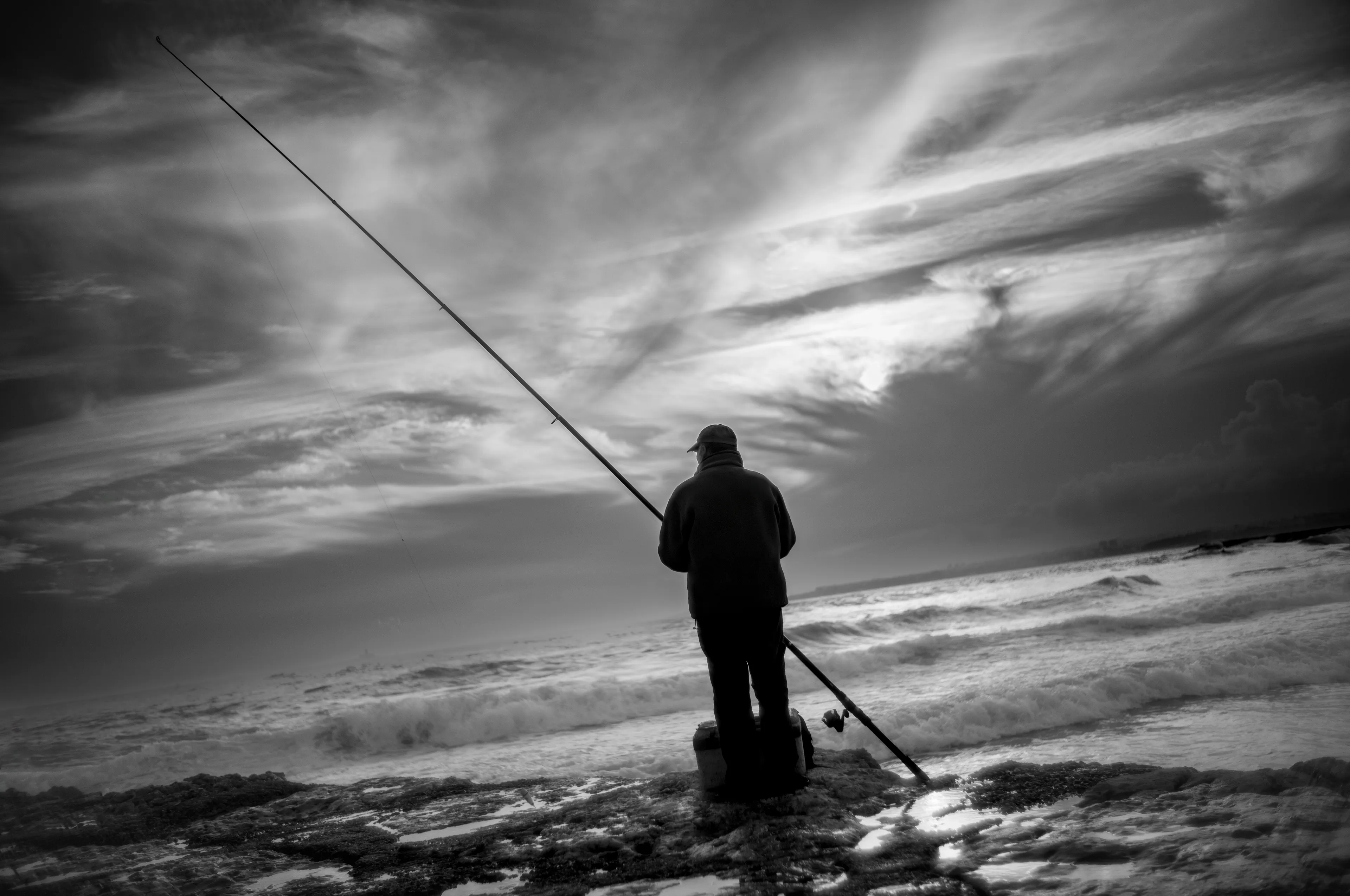 As the fisherman pulled on his rod, the hook anchored in a cloud and ripped the landscape apart. A flood of light poured from the tear. He saw his daughter, nieces, nephews, late wife, and the choir in Lisbon where he sang as a young pupil. He’d torn through the time/space continuum and all his memories played before him like a Super 8 film. He never knew he’d vanished. His life projected onto the Atlantic Ocean, over and over… like the waves.