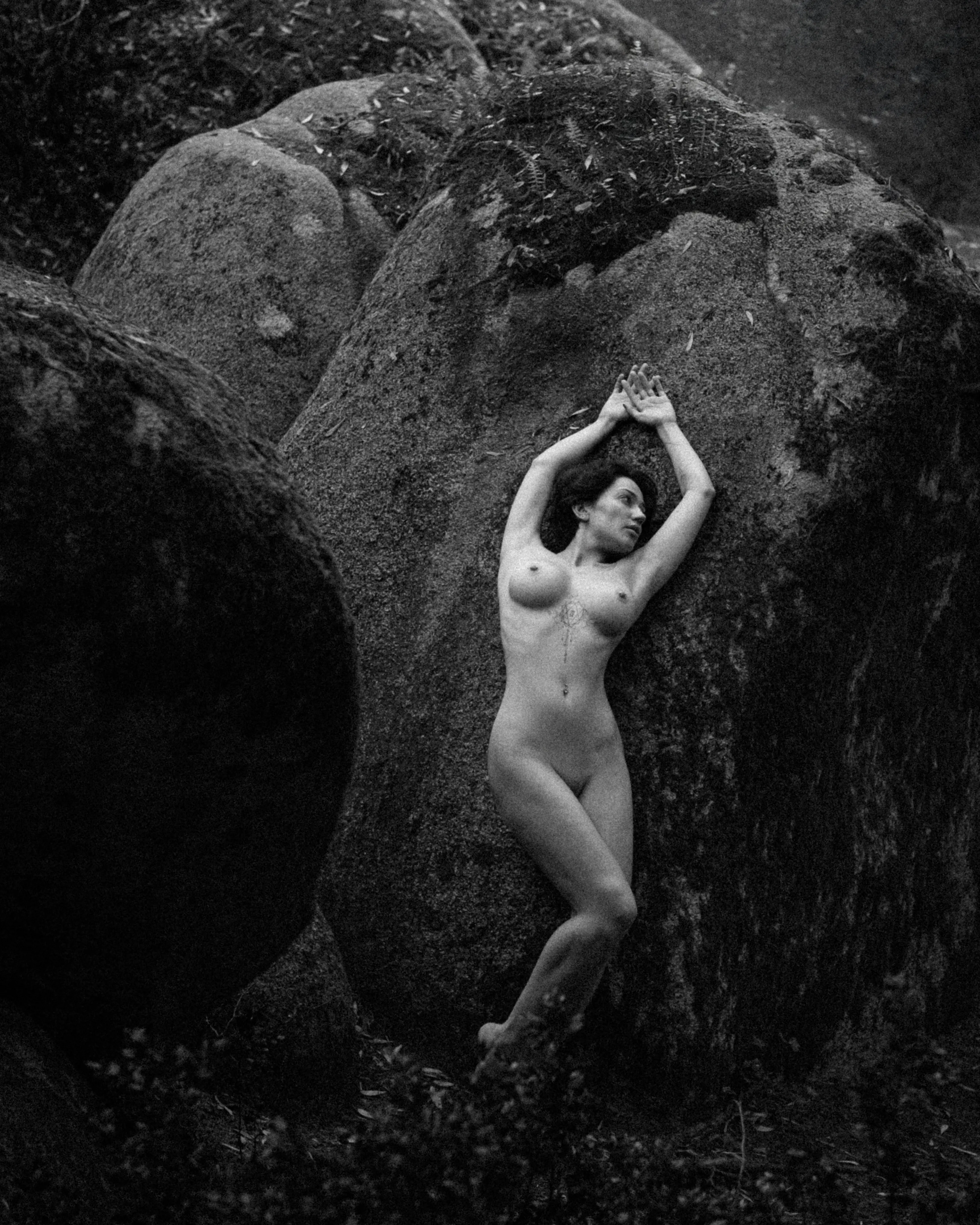 <p>Her body curves against the ancient stone, a silent dance of flesh and rock.</p>