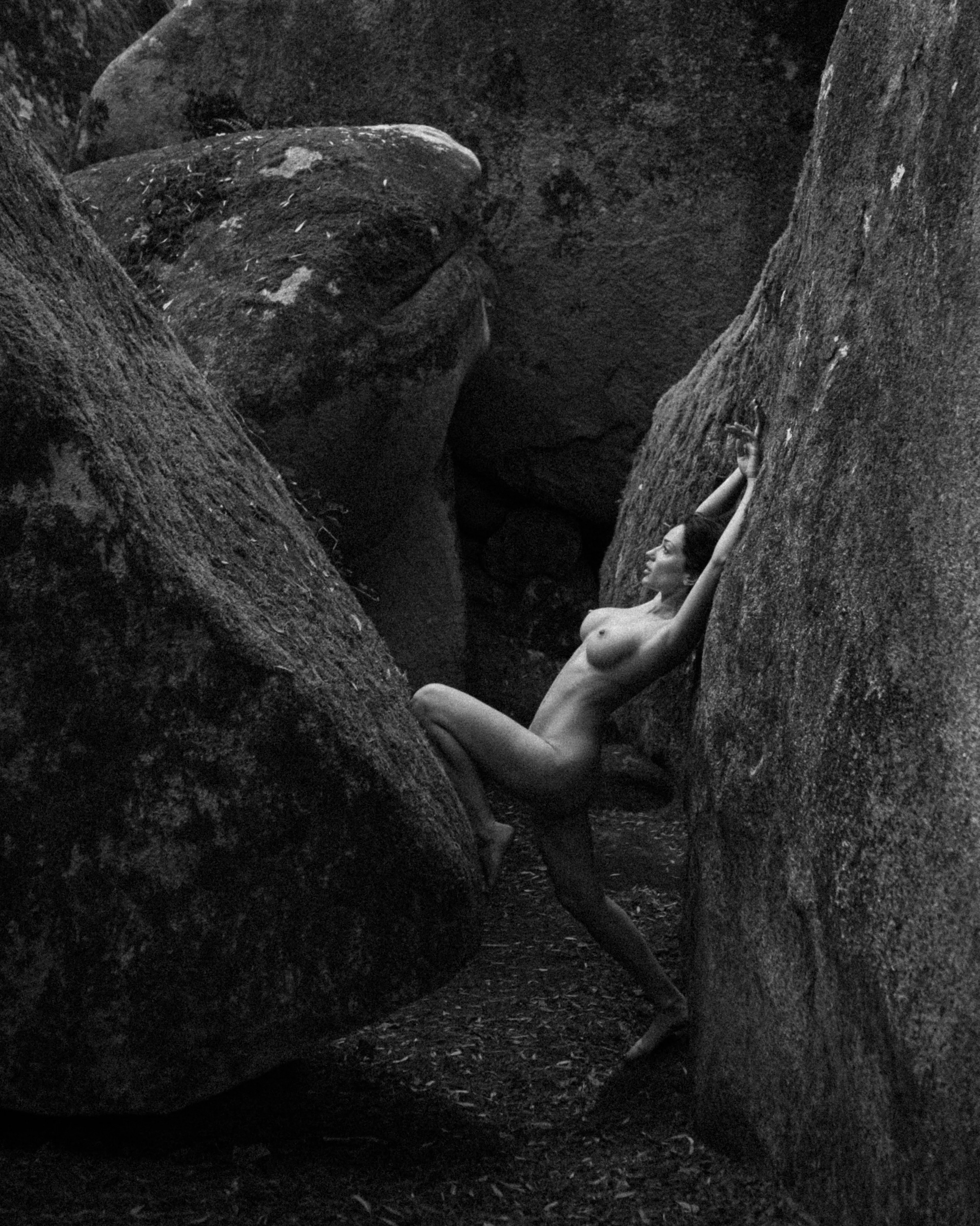 She melts into the earth, a fluid form, both soft and strong, molded by nature.
