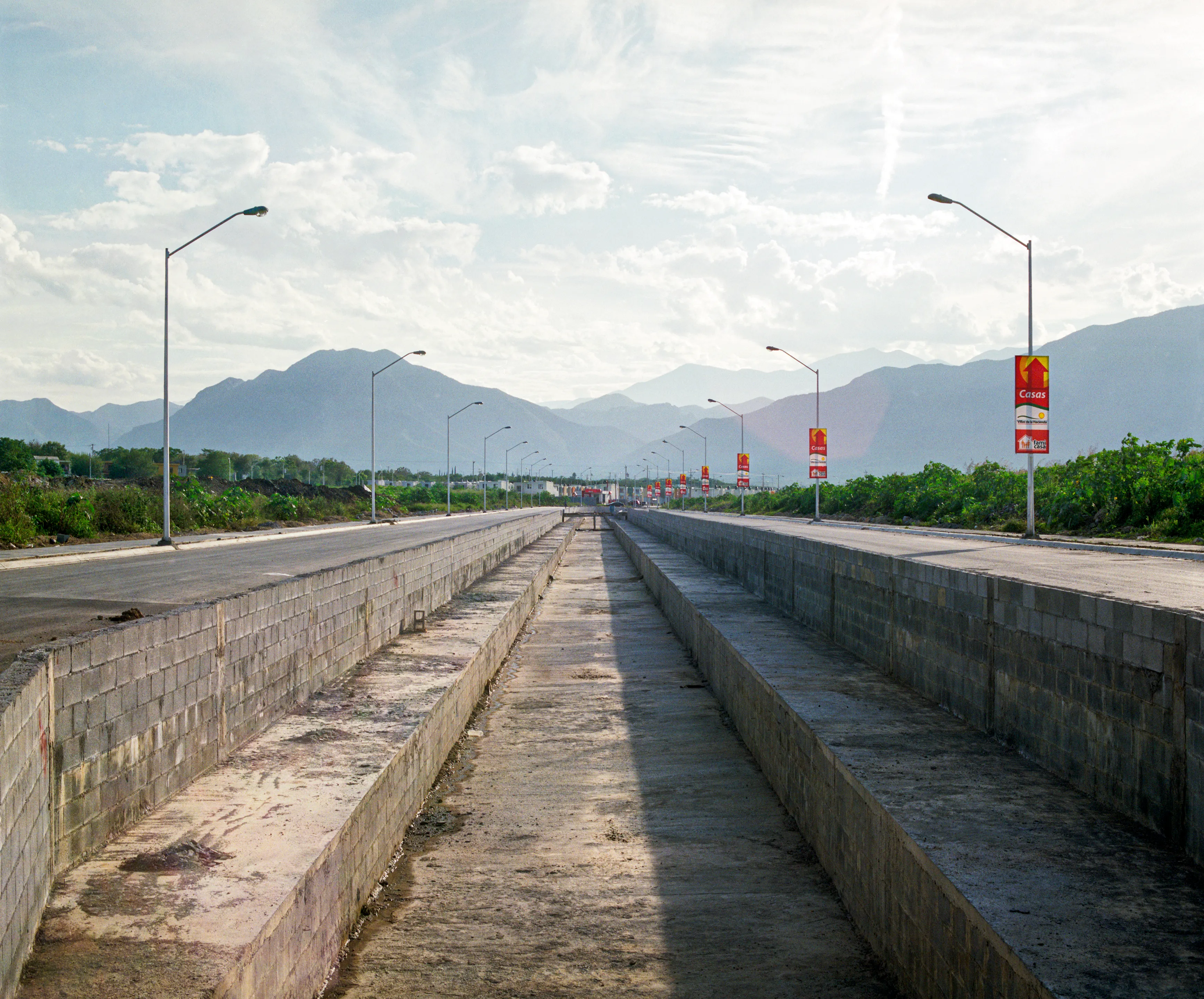 State of Nuevo León, Mexico, 2005-2010. This image is part of a 5-year project called Suburbia Mexicana. I wanted to document some of the unintended consequences of the housing bubble many cities in Mexico were going through. I was also very interested in the aesthetic questions posed by using ultra beautiful landscape imagery to represent ecological degradation. It is a nod to the romantic use of tragedy in paintings; a visual exploration of the grandeur of disaster as a way to comment on the other side of Mexico’s copy pasted ideals of homeownership.