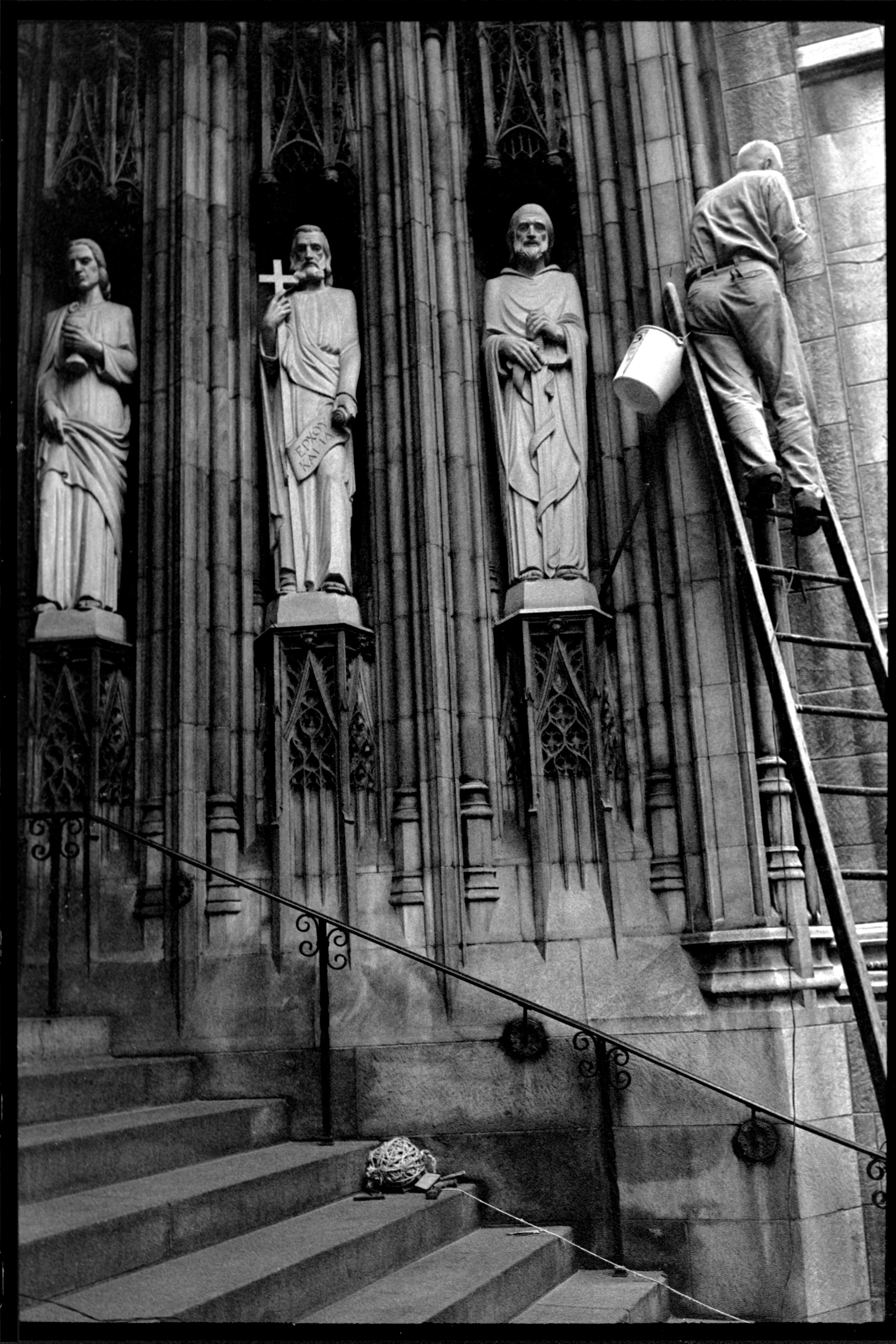 Church Entrance, New York City, USA, 1964

The entrance to a New York City church, photographed in 1964, presents a man on a ladder, his activity seemingly connected to three saints and their relationship to Sequels #11.