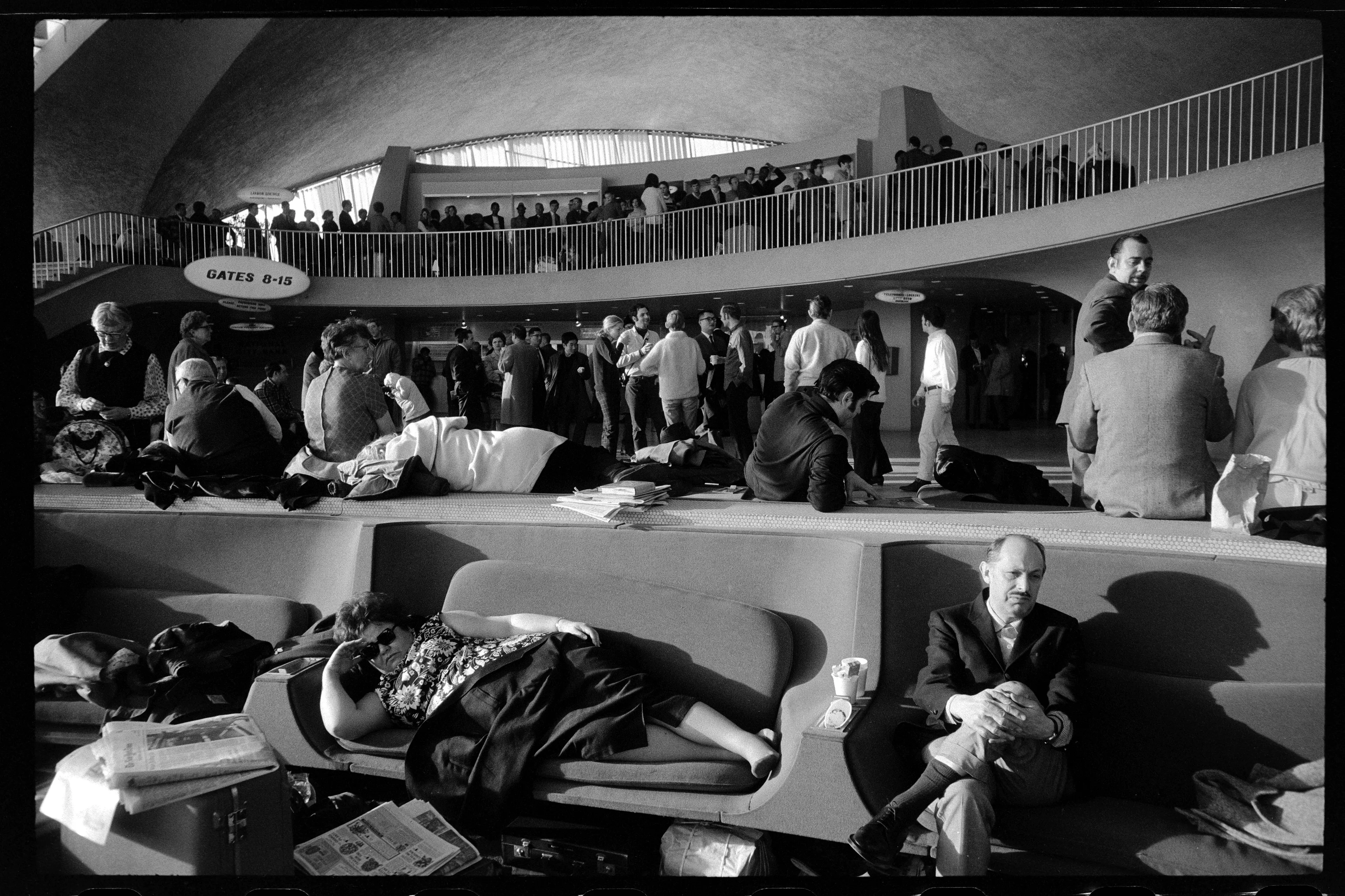 Blizzard At JFK Airport, Camping Out In TWA Terminal, Three Days, 1969

Inside the TWA lounge, 1969, stranded passengers adapt to their temporary confines, a testament to human ingenuity and endurance amid unexpected challenges.