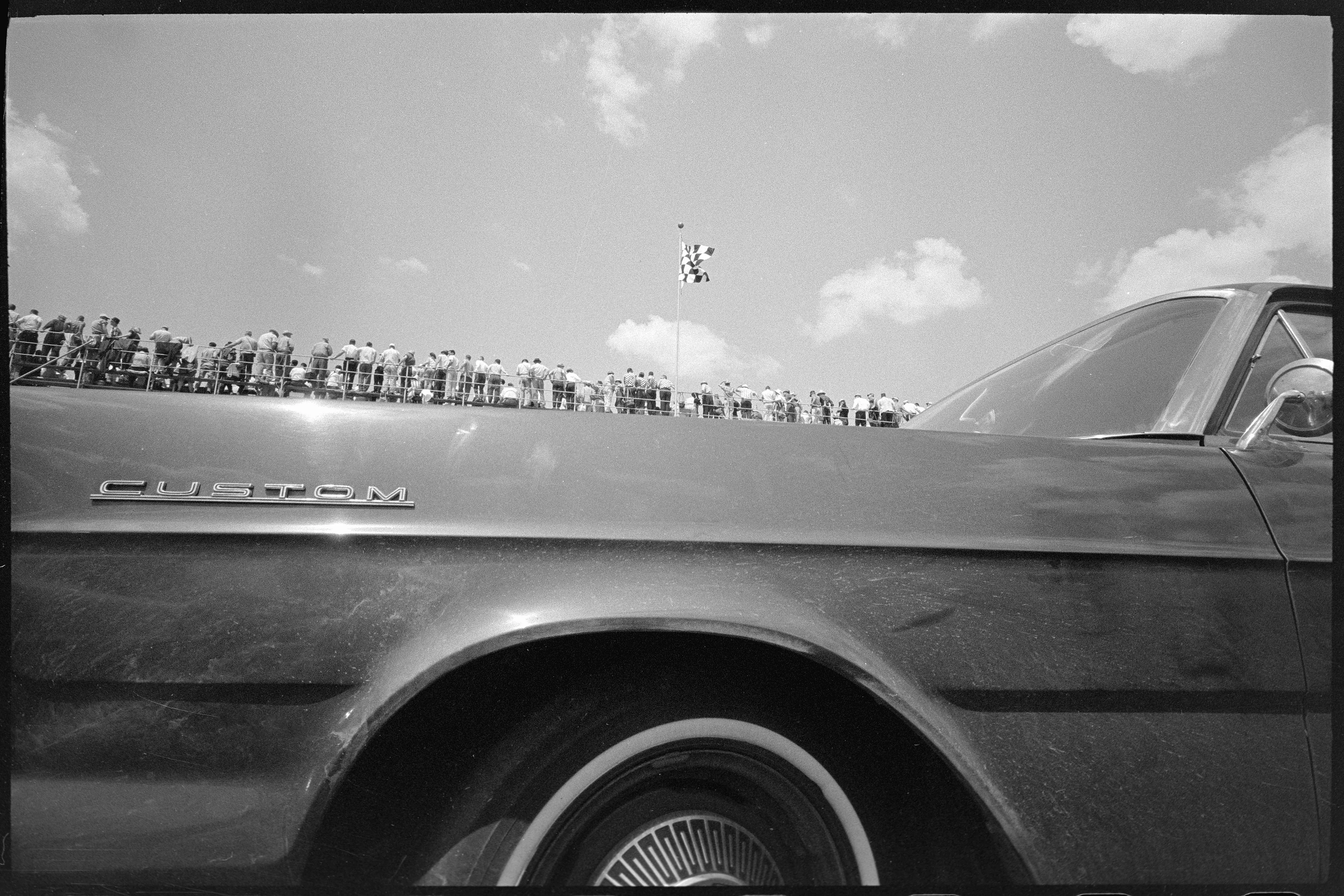 Indy 500, Car With Small Figures Above, Indianapolis, Indiana, USA, 1965

Joel Meyerowitz embarked on an extensive journey across Europe between 1966 and 1967, his travels taking him to numerous countries including France, Greece, Spain, Germany, Turkey, Bulgaria, Morocco, England, Ireland, Wales, and Scotland.