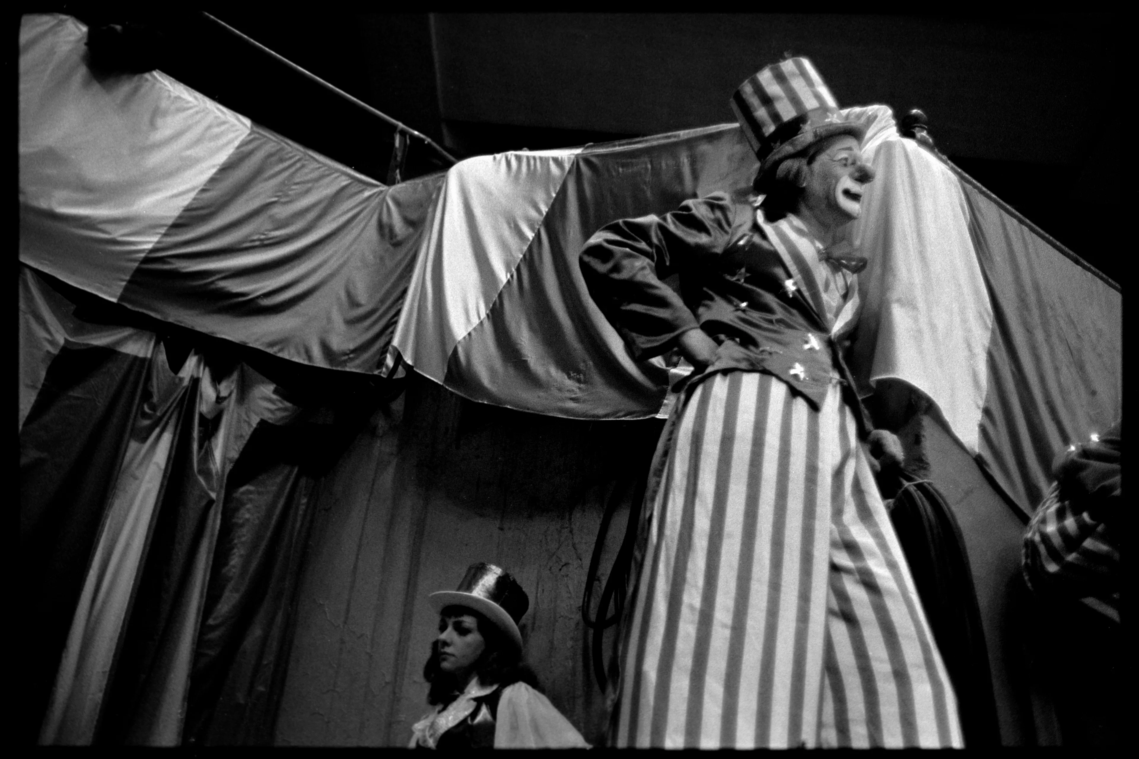 A Clown on Stilts, NYC, 1964

A clown on stilts, captured in 1964, epitomizes the whimsical nature of circus performances. The behind-the-scenes perspective offers a glimpse into the less glamorous, yet equally fascinating, aspects of circus life during its heyday.