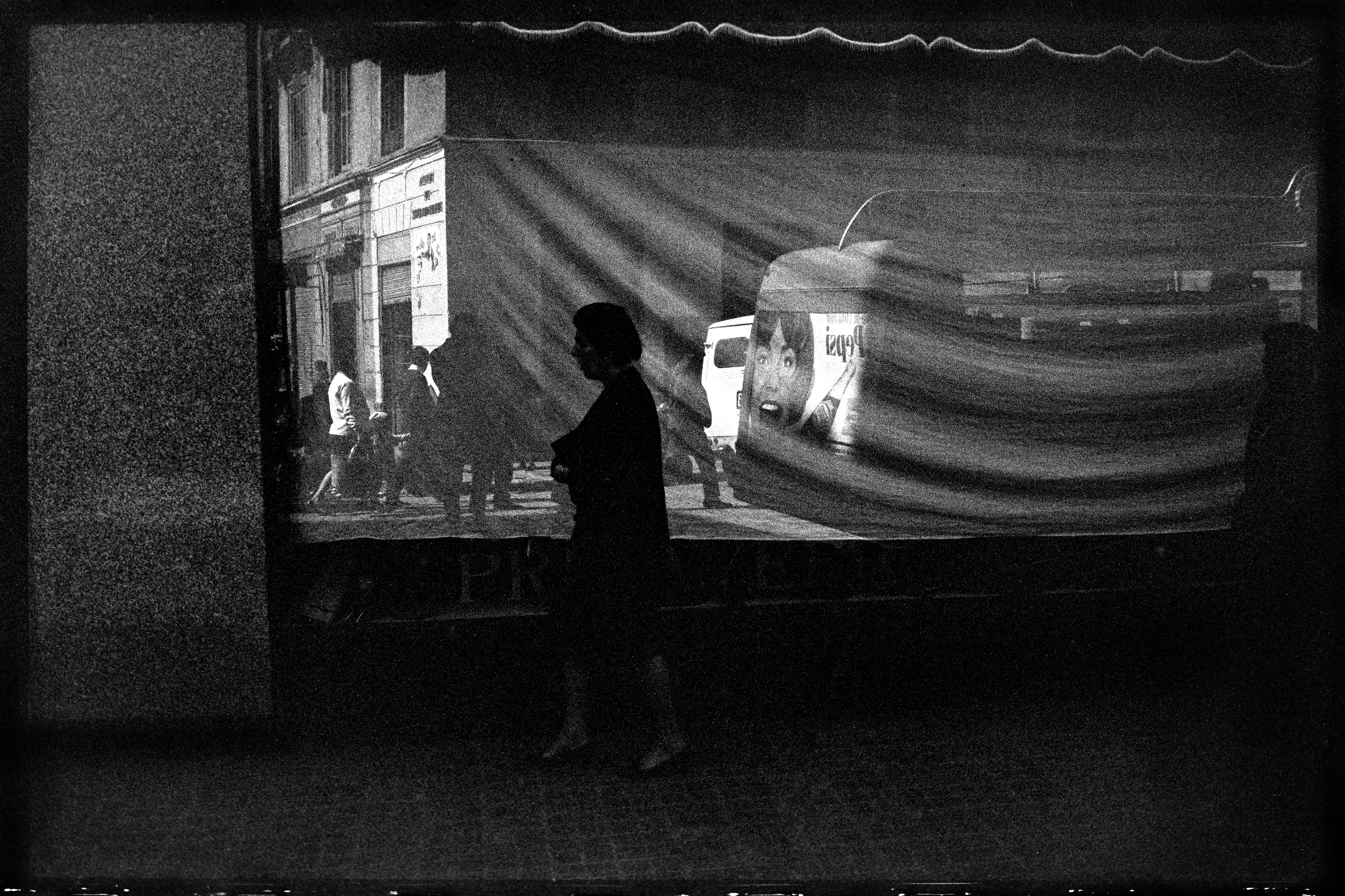 Málaga, Spain, 1966

A streetscape in Málaga, Spain, features a window adorned with curtains, reflecting the street view almost like the movie screen captured in Sequels #7.