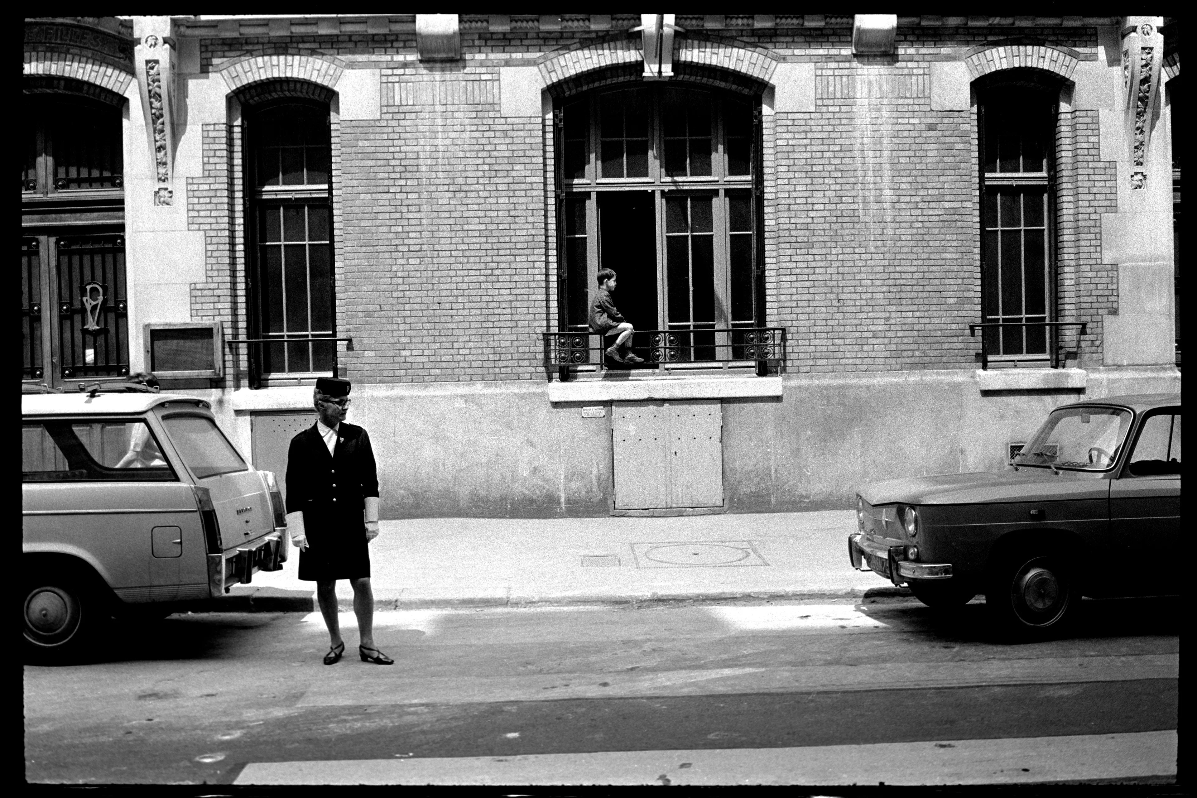 Boy sits on window, Paris, 1967

In Paris, 1967, a timid boy sits just a few feet above the ground, riding a railing. The juxtaposition of his timidity against the act of balancing created a humorous effect. As I construct these sequences, I strive to find connections and flowing imagery, offering viewers an engaging journey.