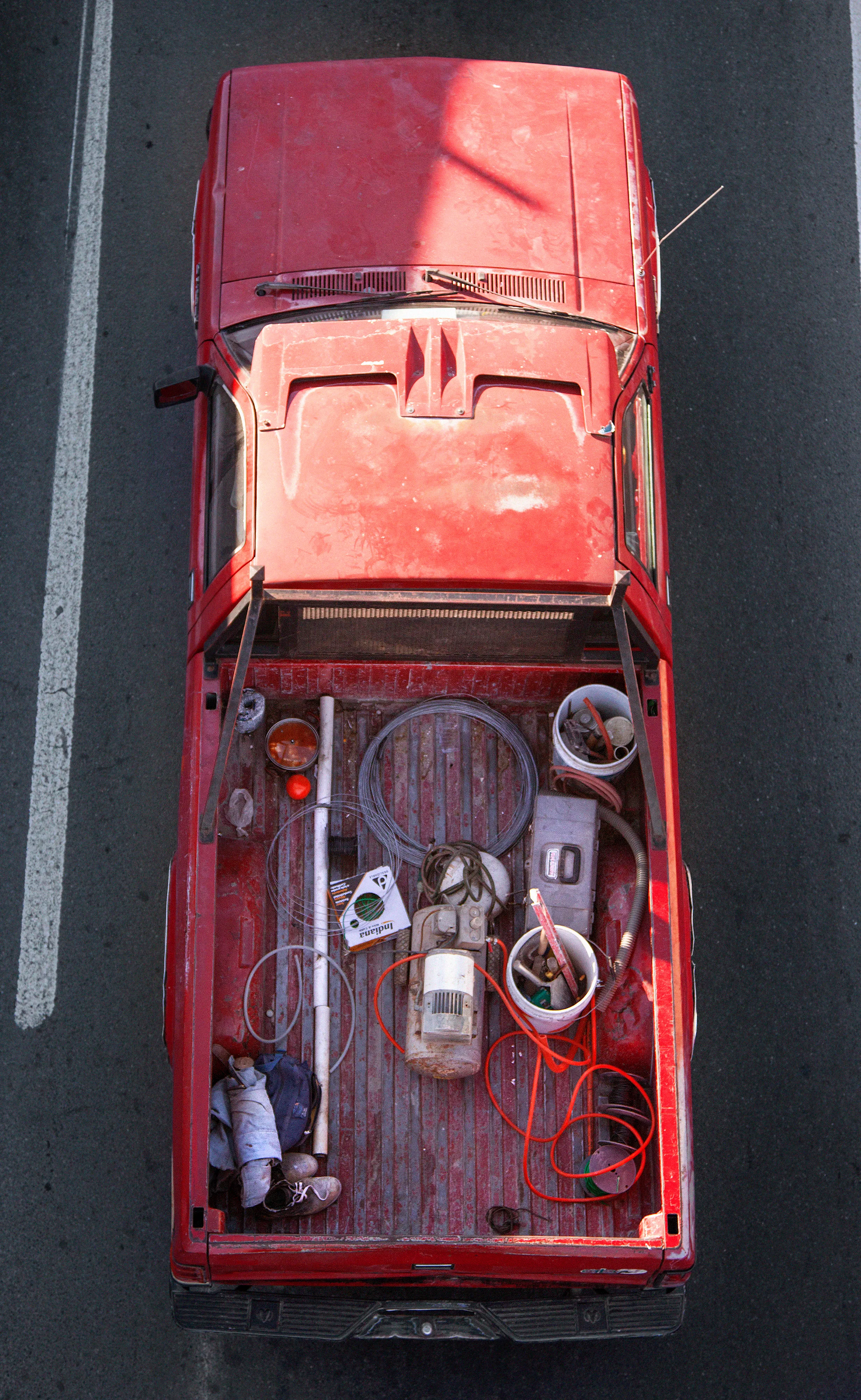 In Urban Transportation, Cartagena focuses on various modes of transportation used by workers in urban environments, particularly highlighting the ubiquitous red trucks. Shooting cars and trucks as they drive to work in the morning, Cartagena has been able to capture a stunning snapshot of what is the daily routine of a city. The colors and textures of the vehicles and objects, mixed with the contemporary idea of customizing vehicles make for arresting imagery of a contemporary Mexican city.