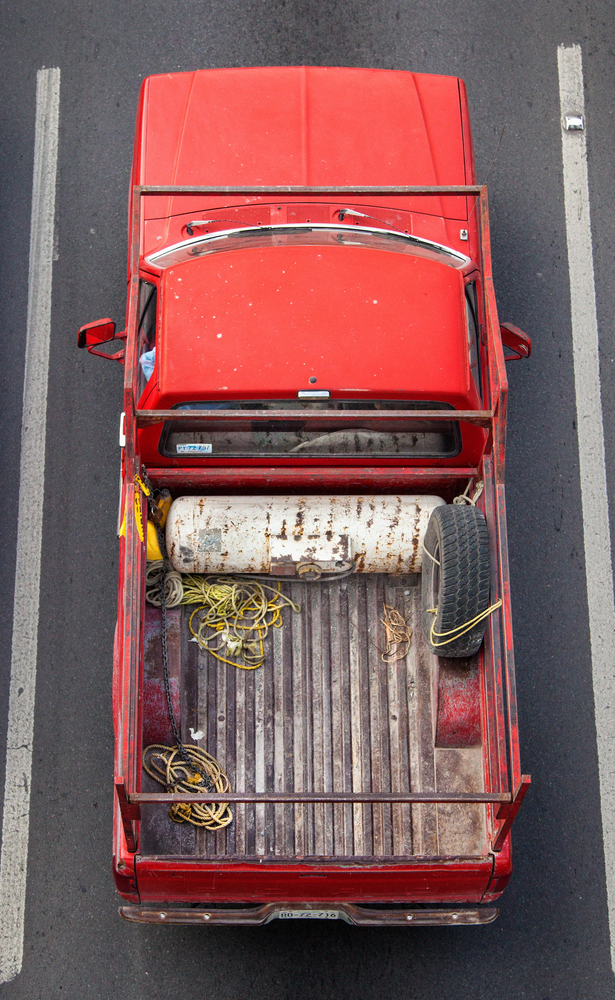 In Urban Transportation, Cartagena focuses on various modes of transportation used by workers in urban environments, particularly highlighting the ubiquitous red trucks. Shooting cars and trucks as they drive to work in the morning, Cartagena has been able to capture a stunning snapshot of what is the daily routine of a city. The colors and textures of the vehicles and objects, mixed with the contemporary idea of customizing vehicles make for arresting imagery of a contemporary Mexican city.