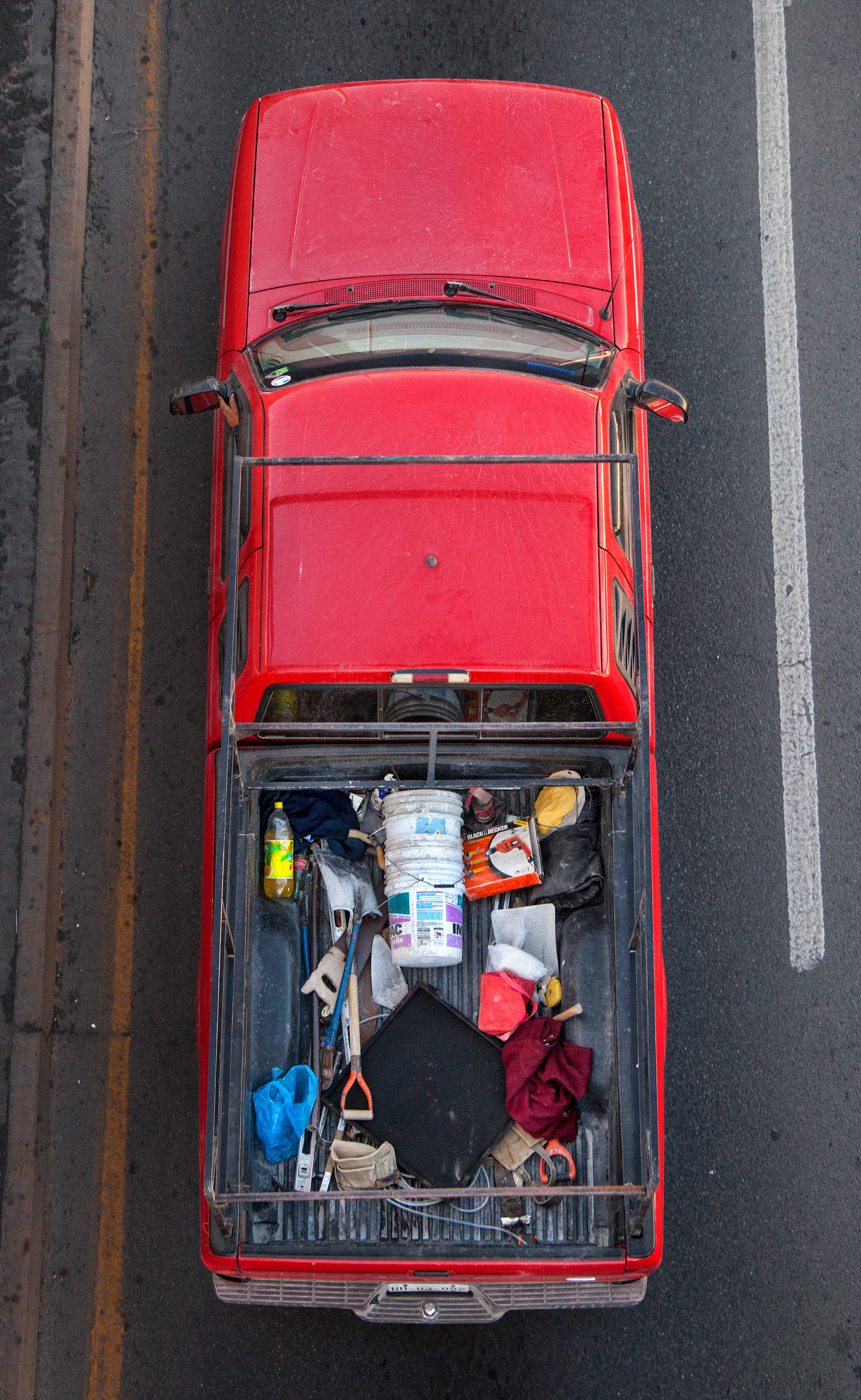 In Urban Transportation, Cartagena focuses on various modes of transportation used by workers in urban environments, particularly highlighting the ubiquitous red trucks. Shooting cars and trucks as they drive to work in the morning, Cartagena has been able to capture a stunning snapshot of what is the daily routine of a city. The colors and textures of the vehicles and objects, mixed with the contemporary idea of customizing vehicles make for arresting imagery of a contemporary Mexican city.